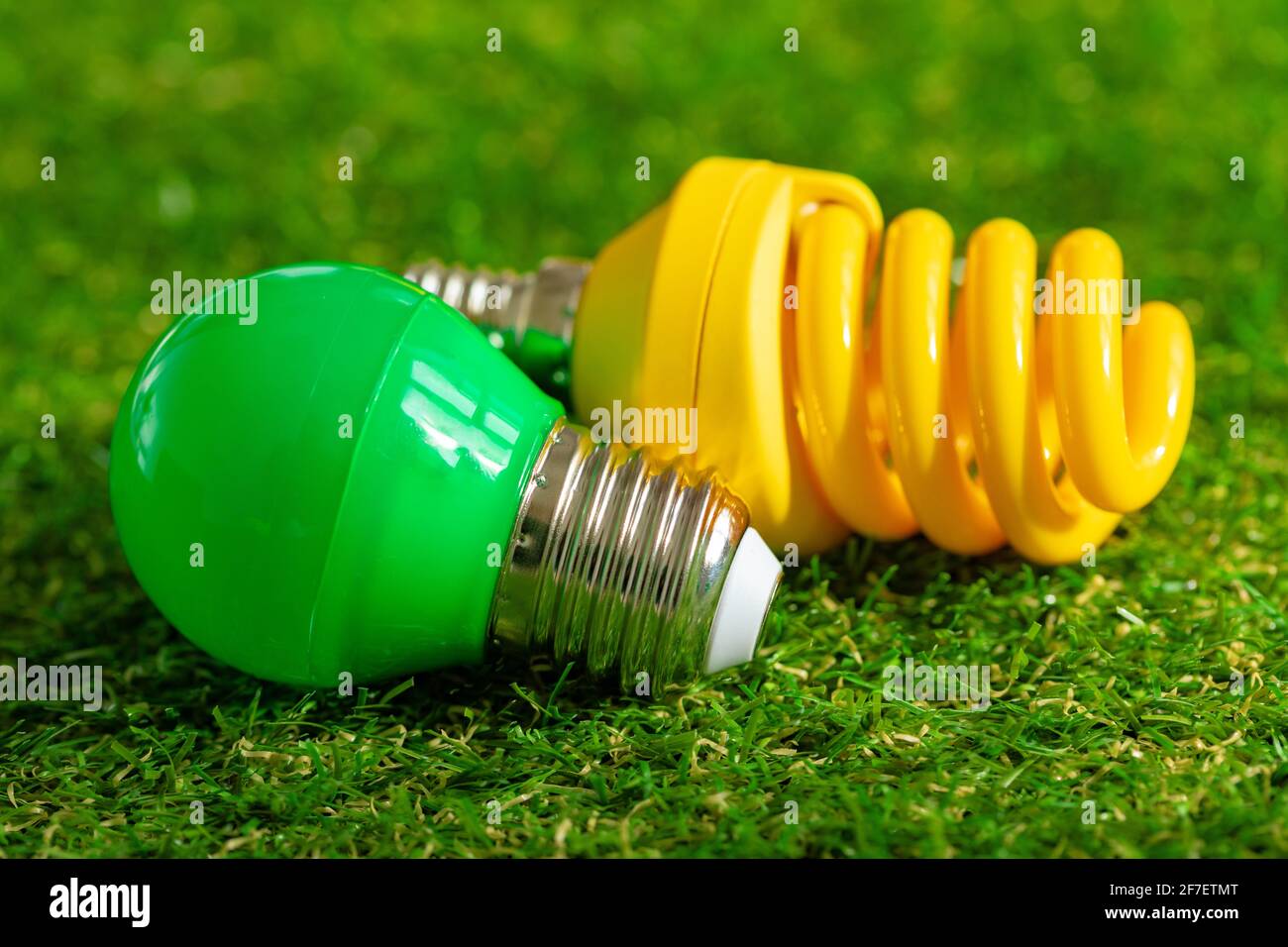 Energy efficient light bulb lying on grass Stock Photo - Alamy