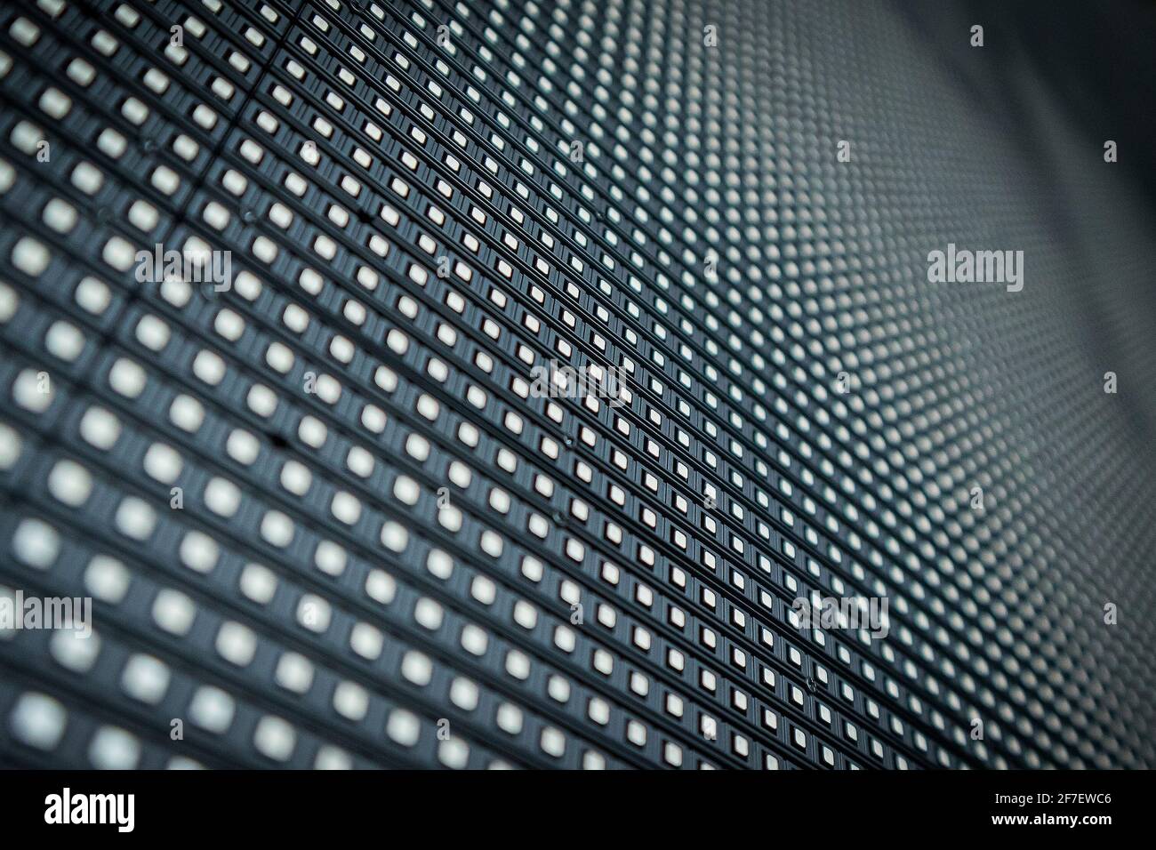 Detail of a LED or LCD panel for screen on concerts or different displays. Focus on a centre row of LED lights, others in soft focus. Array of LED RGB Stock Photo