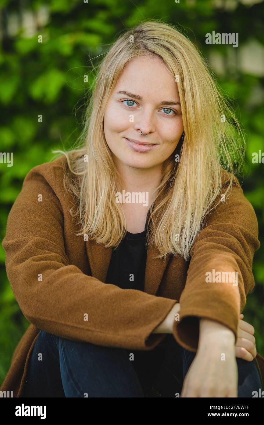 Smiling blonde girl sitting crossed hi-res stock photography and images ...
