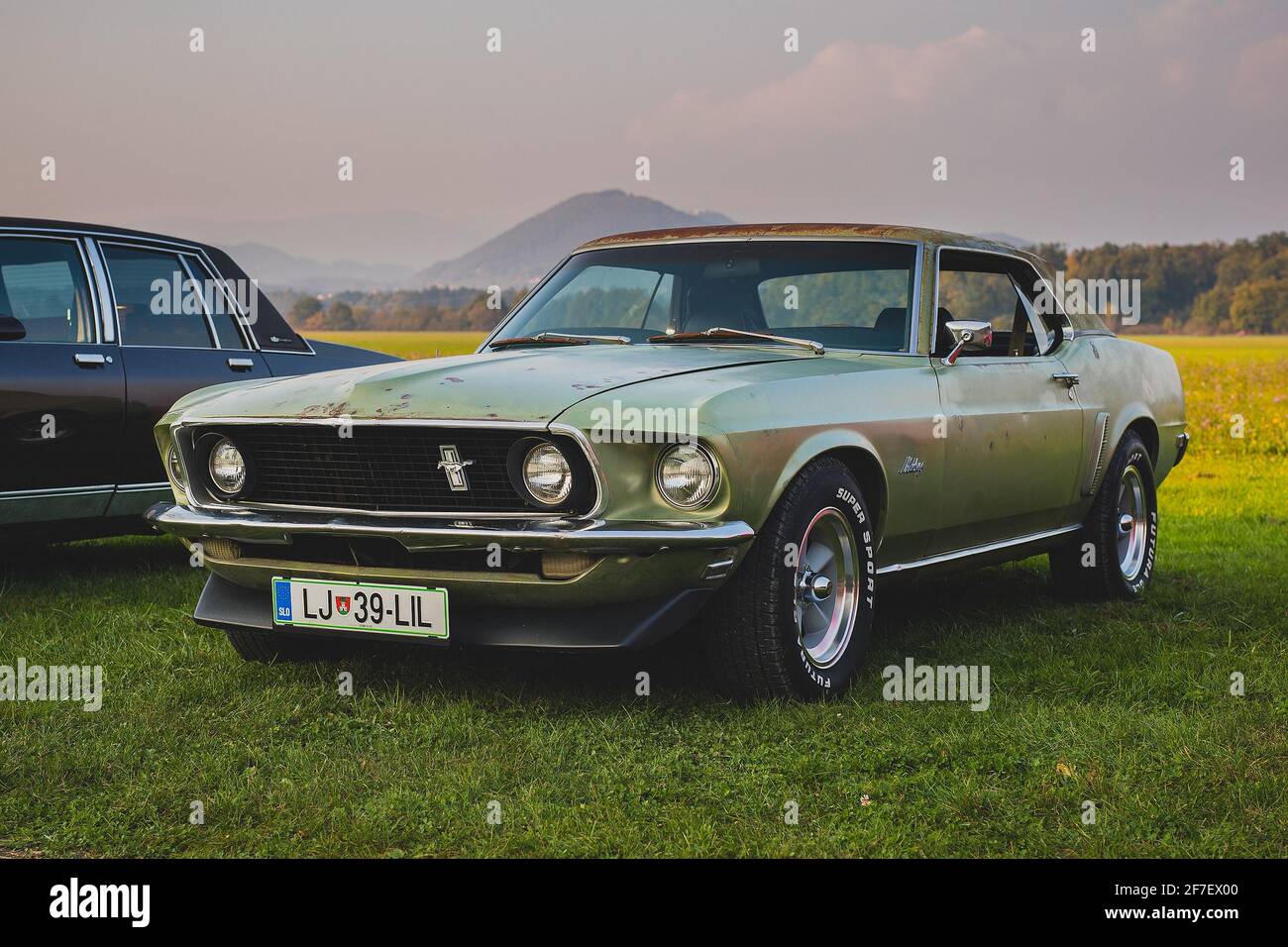 LEVEC, SLOVENIA, 20. OCTOBER 2018: vintage 1969 mustang in green color with serious patina, rat looking vintage muscle car with some rust on it. Stock Photo