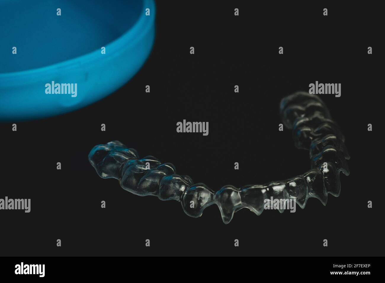 Orthodontic retainer made from transparent plastic isolated on wblack