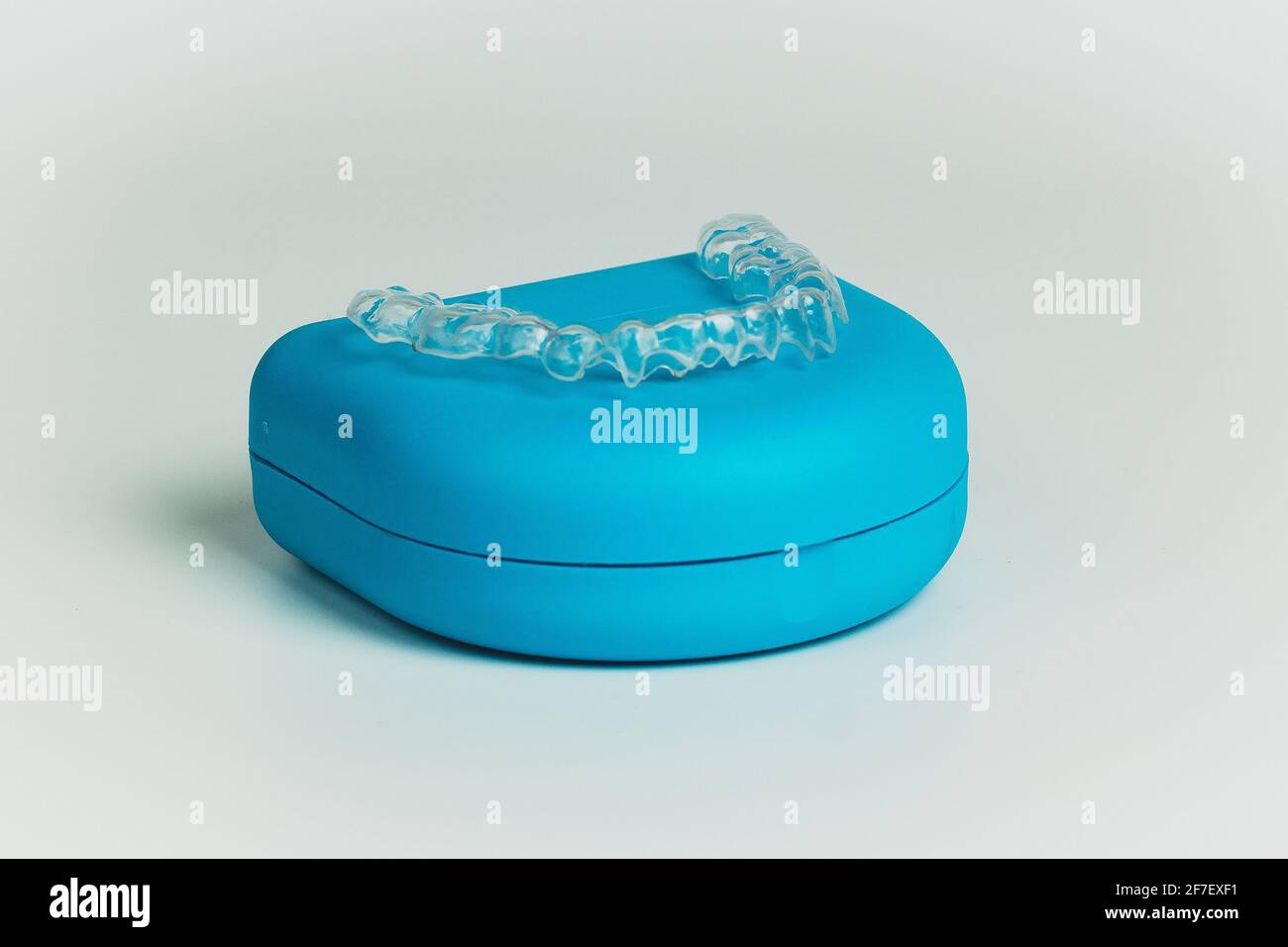 Blue carrying case for orthodontic retainer made from transparent