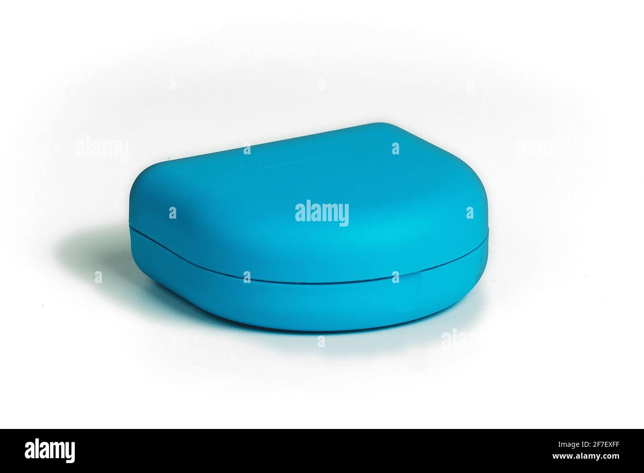 Blue carrying case for orthodontic retainer made from transparent plastic isolated on white