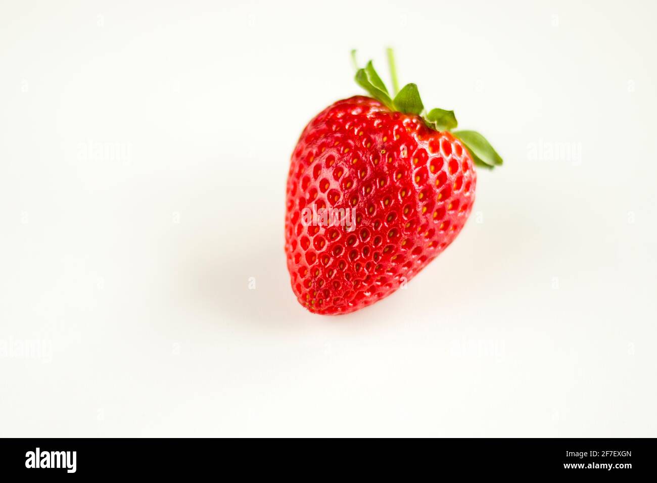 One strawberry on the white background, raw real strawberry, ready to ...
