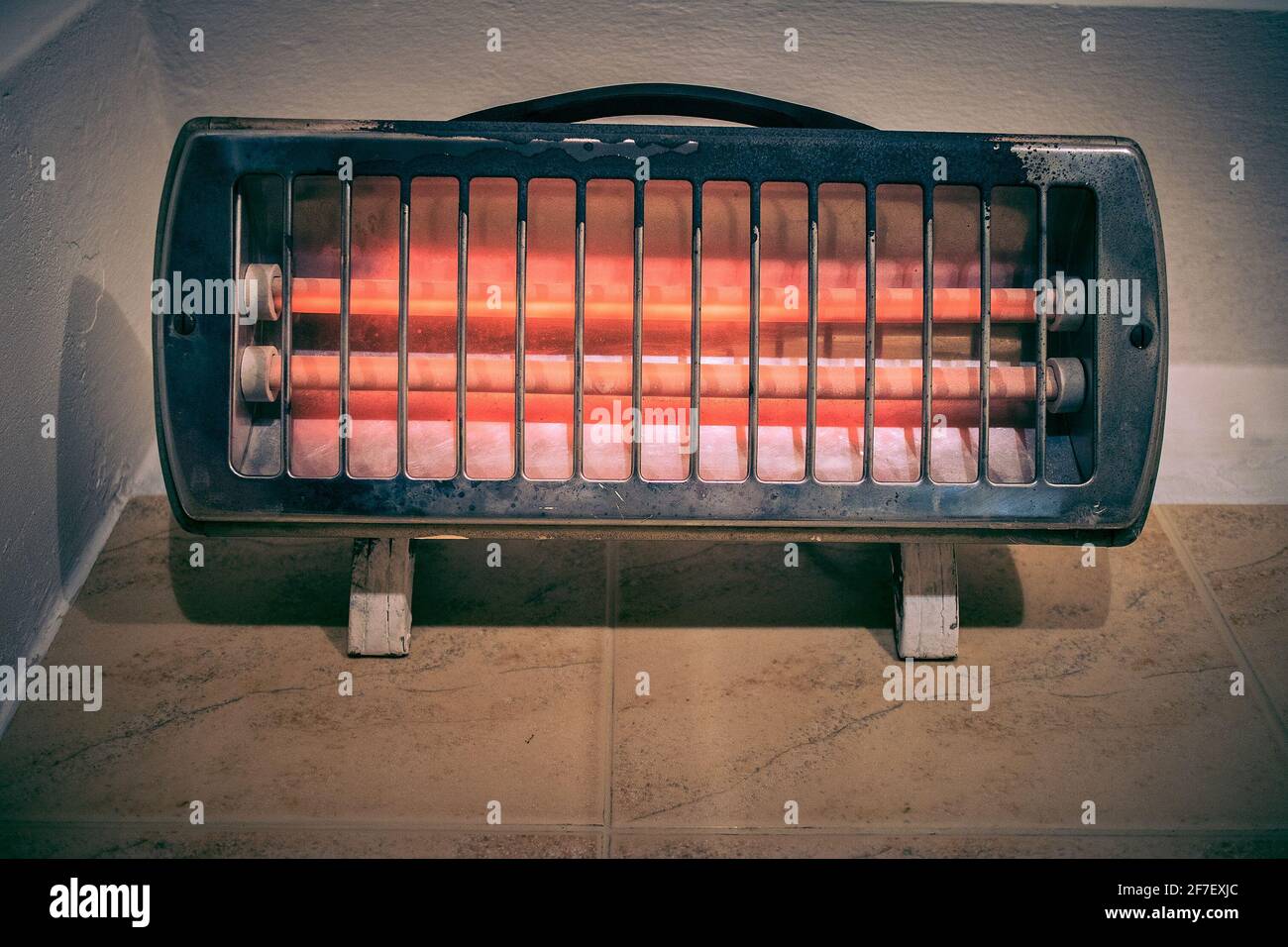 Frontal picture of an old vintage tube infrared heater with protective mesh  in an old bathroom. Efficient and warm appliance for heating but ready for  Stock Photo - Alamy