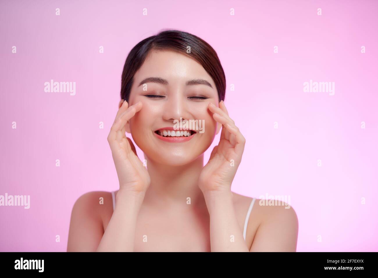 Spa Beauty. Young Model Woman Touching her Hand her Face. Healthy Skin, Facial Treatment and Cosmetology Stock Photo