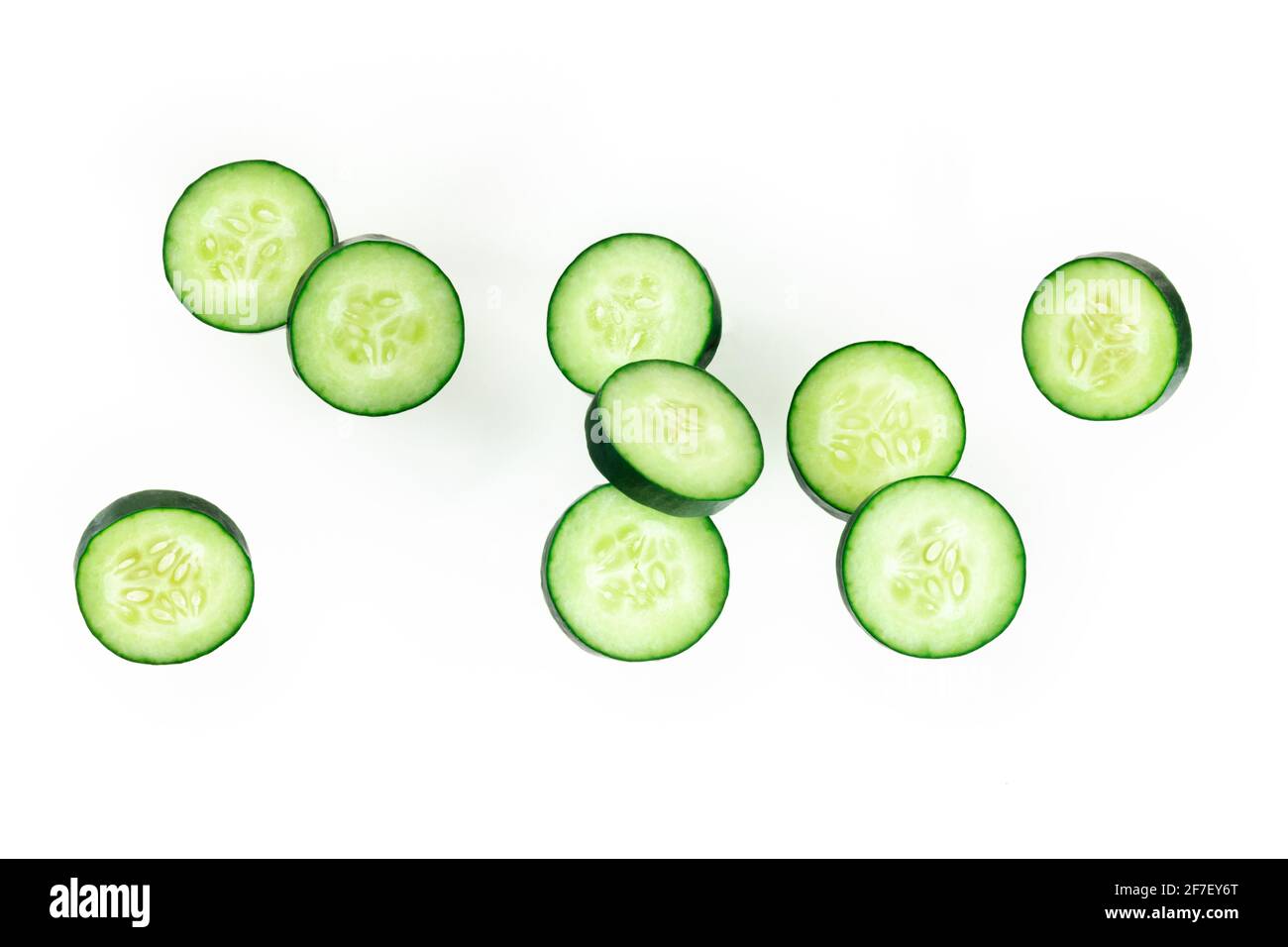 Cucumber slices, levitating on a white background Stock Photo