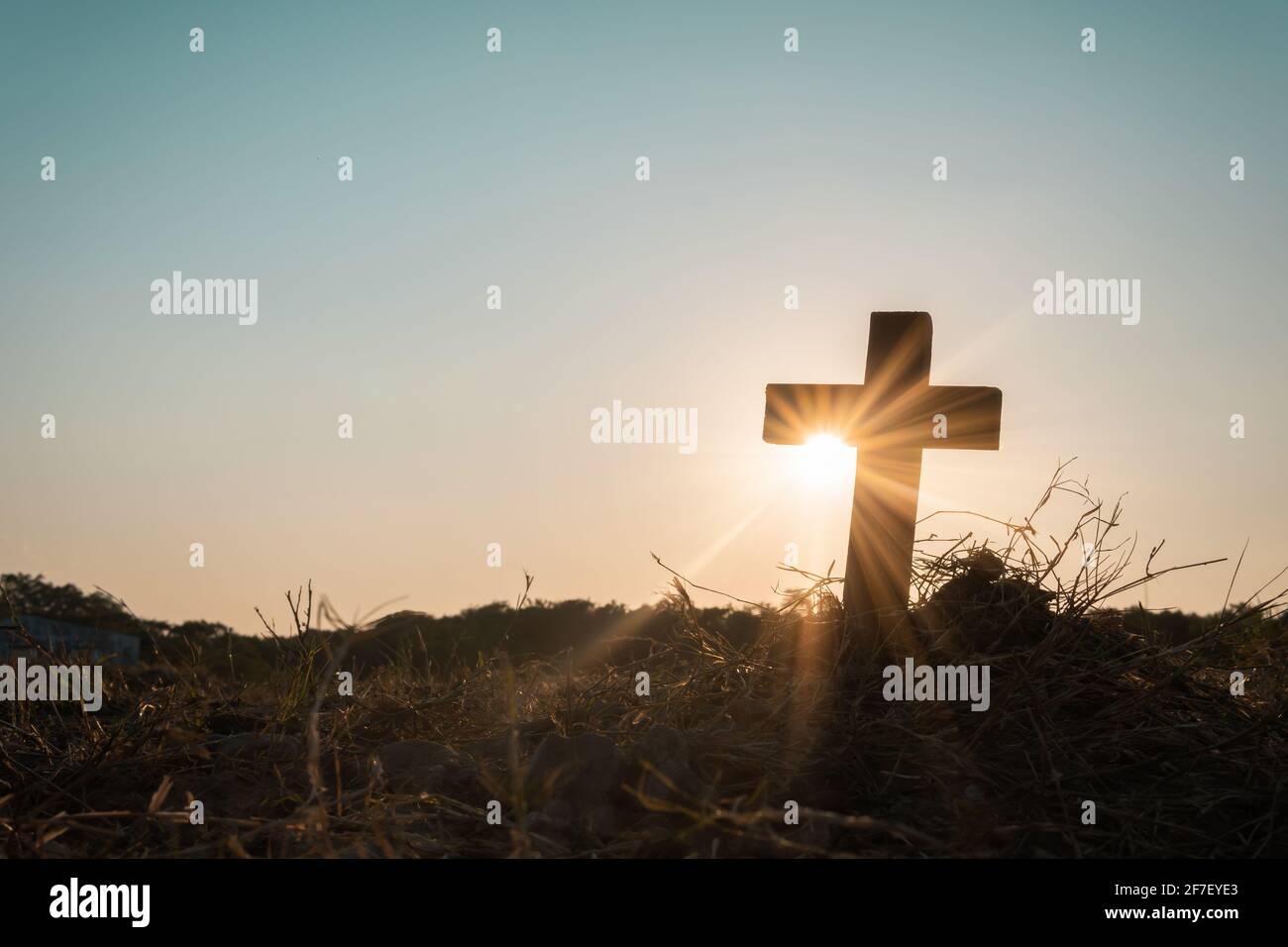 Silhouette jesus christ crucifix on cross on calvary sunset background concept for good friday he is risen in easter day, good friday worship in God, Stock Photo
