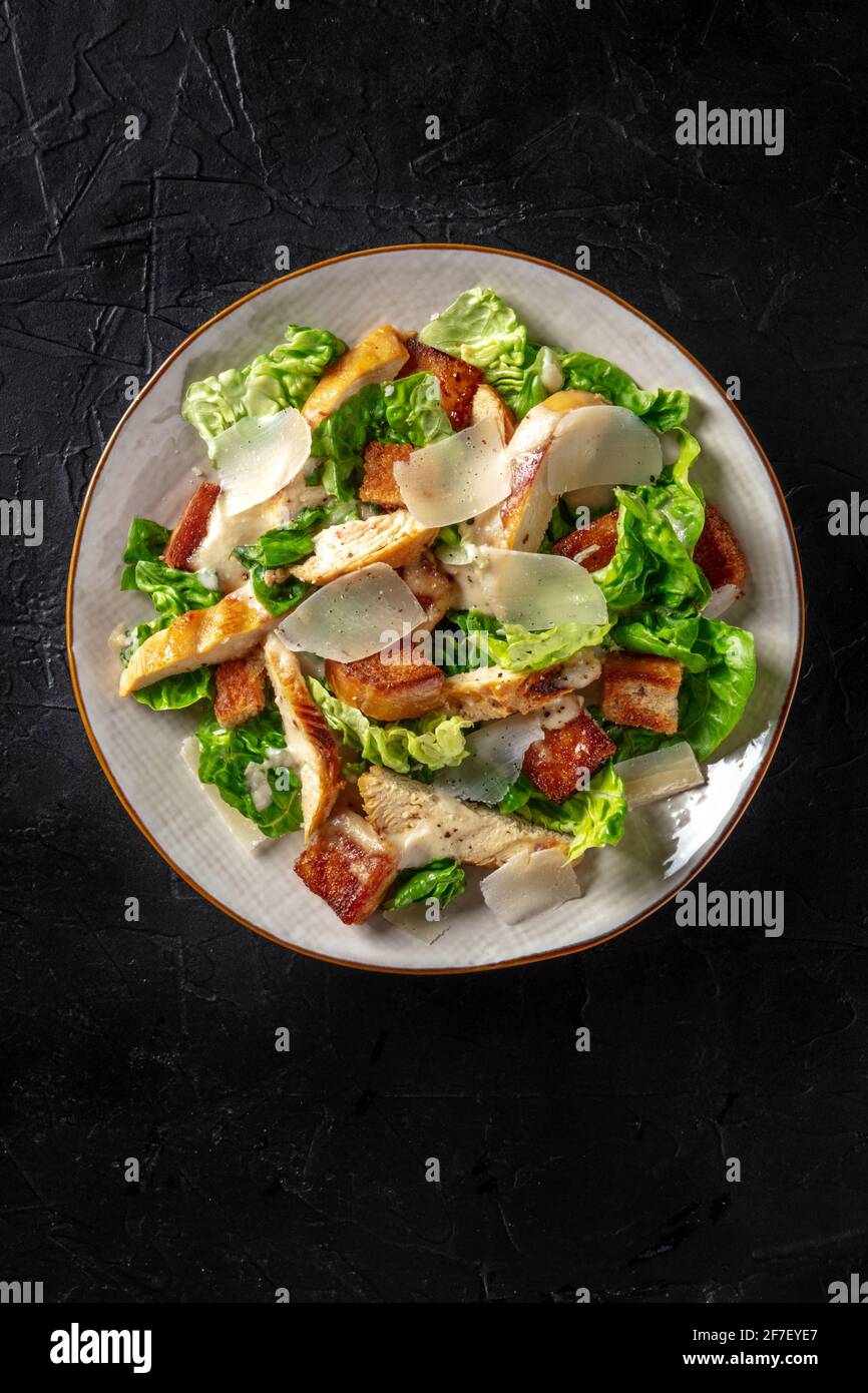 Chicken Caesar salad with lettuce and cheese, shot from the top Stock Photo