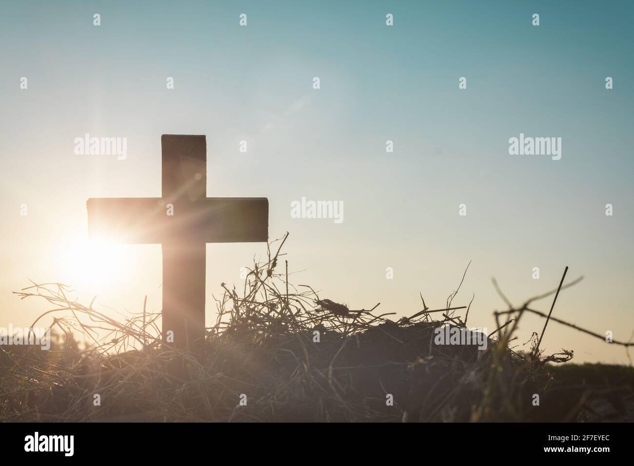 Silhouette jesus christ crucifix on cross on calvary sunset background concept for good friday he is risen in easter day, good friday worship in God, Stock Photo