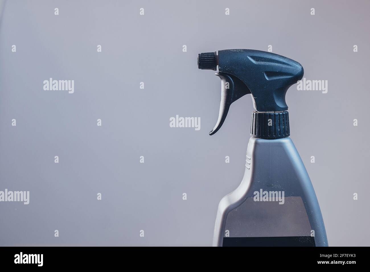Side view of a plastic spray bottle for cleaning and operating it