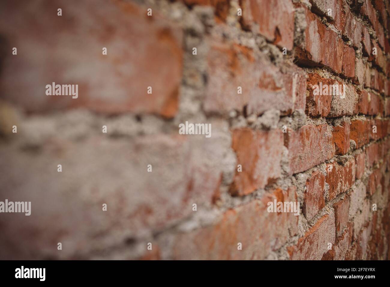 Detail of old brick wall with visible cement stains and leftovers on
