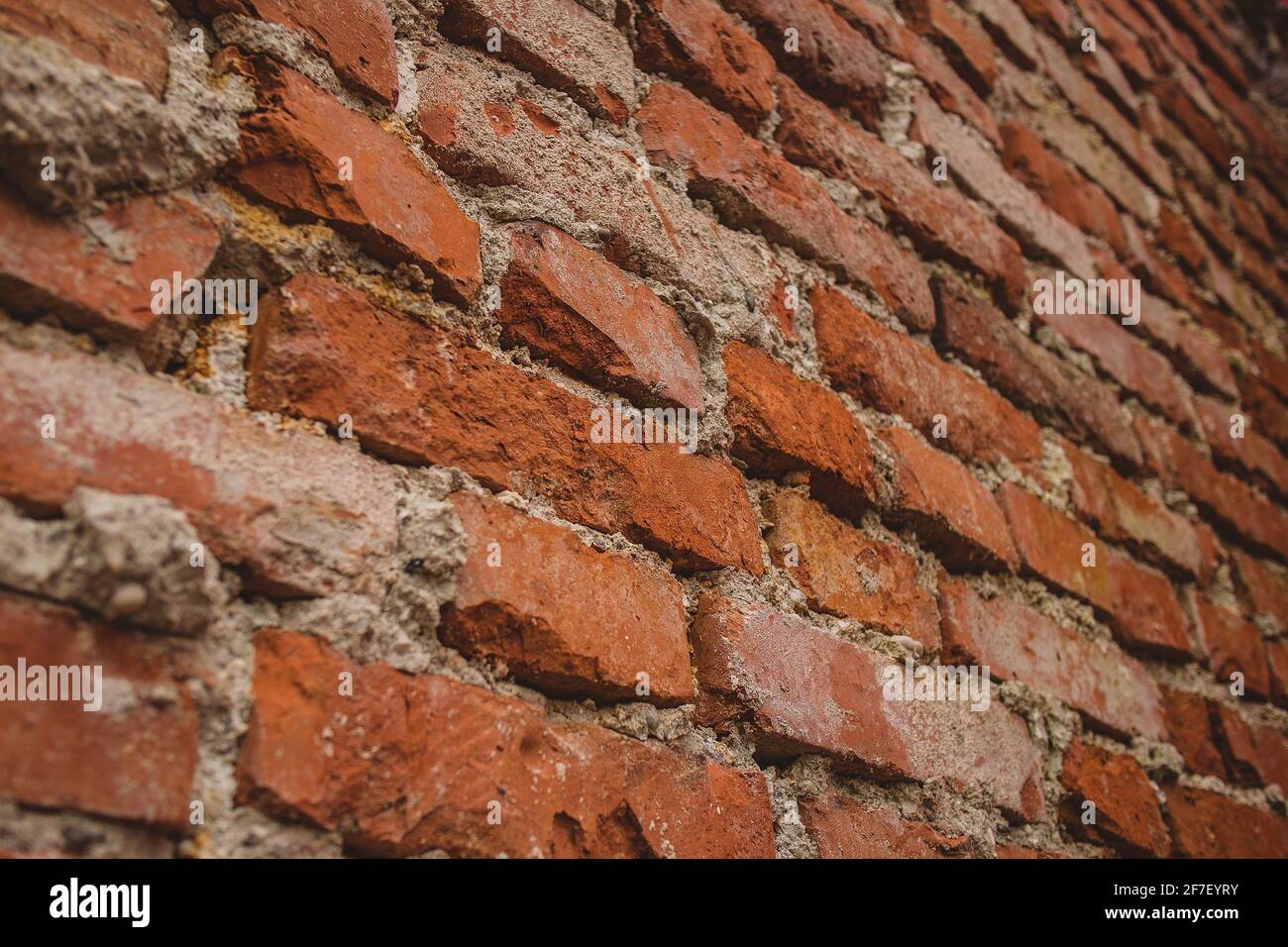 Detail of old brick wall with visible cement stains and leftovers on