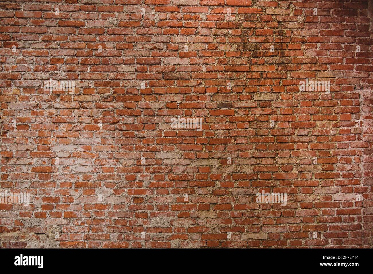Old brick wall with visible cement stains and leftovers on the bricks