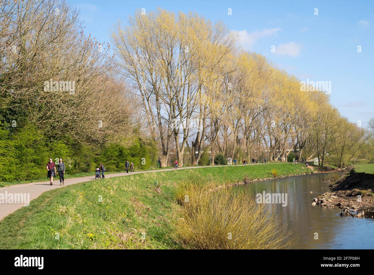 People walking along the riverside path next to the river Mersey in Heaton Mersey, Greater Manchester, England, UK Stock Photo