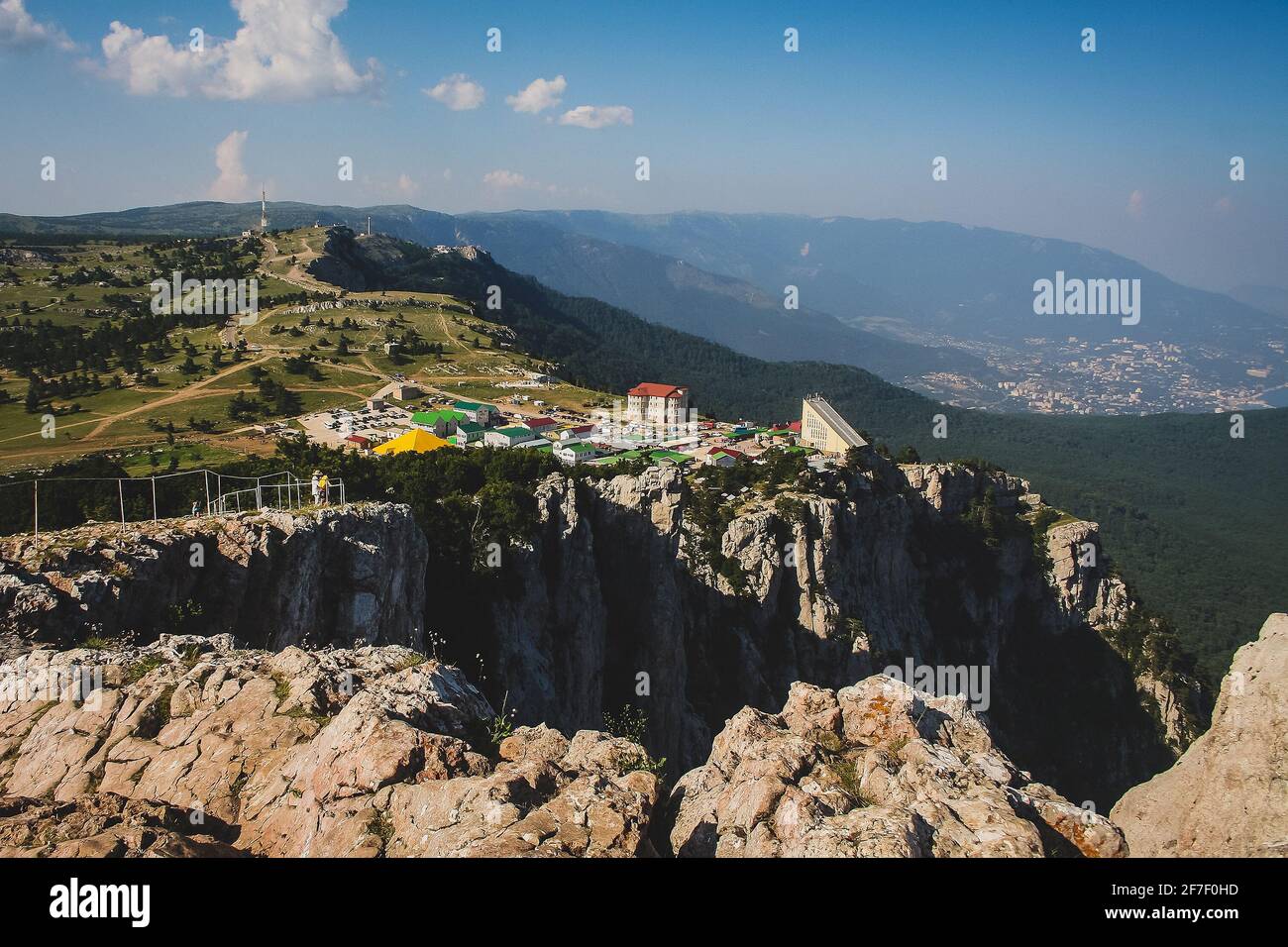 Ay petri mountain on Crimean peninsula wit visible top station of gondola or cable car. City of Yalta in the background. Stock Photo
