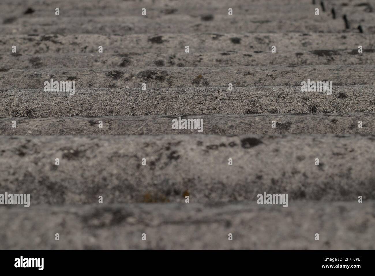 Old roofing tiles made of asbestos and cement. Dangerous and unhealthy
