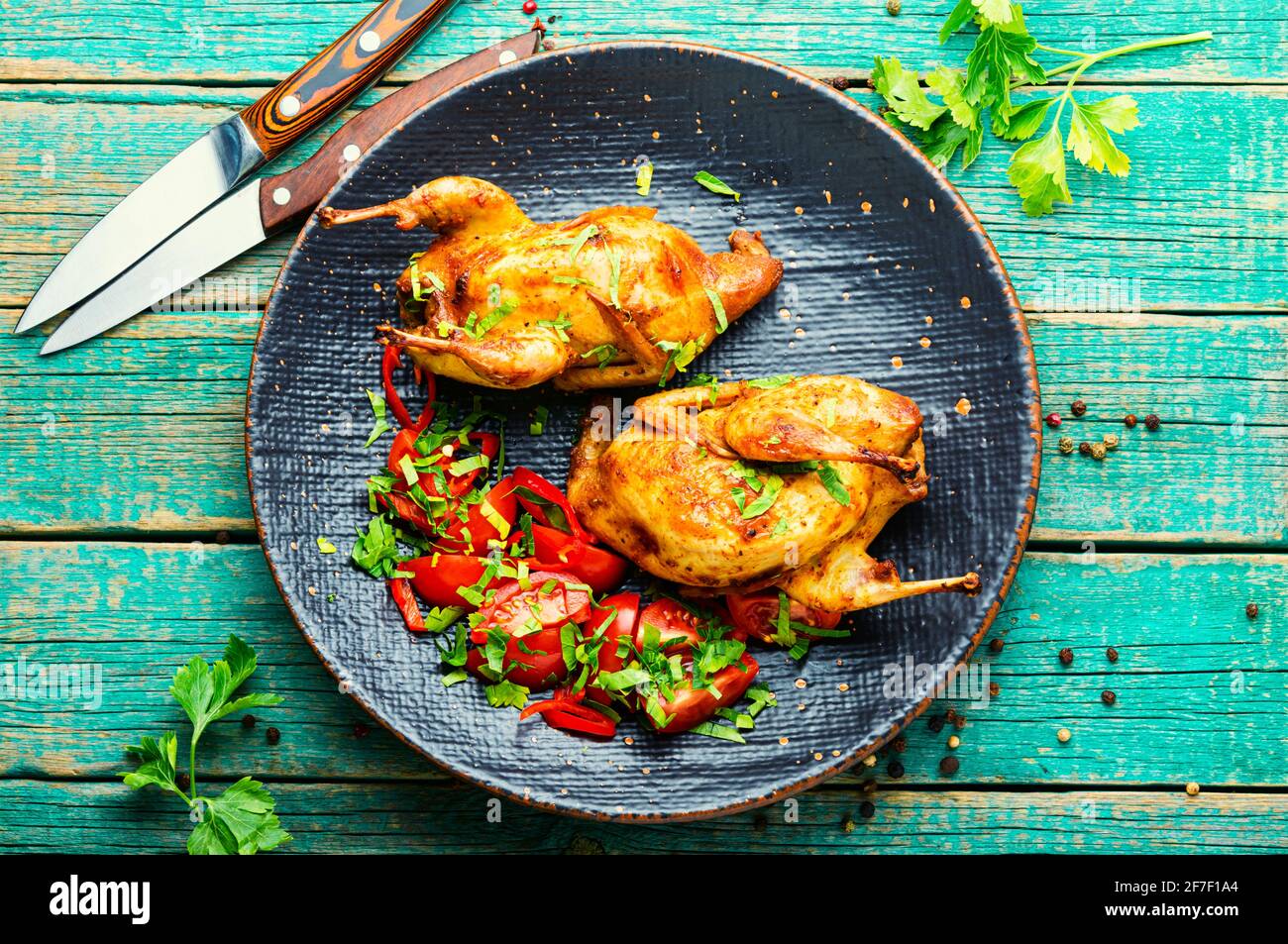 Roasted whole quail and spring vegetable salad.Appetizing baked quail