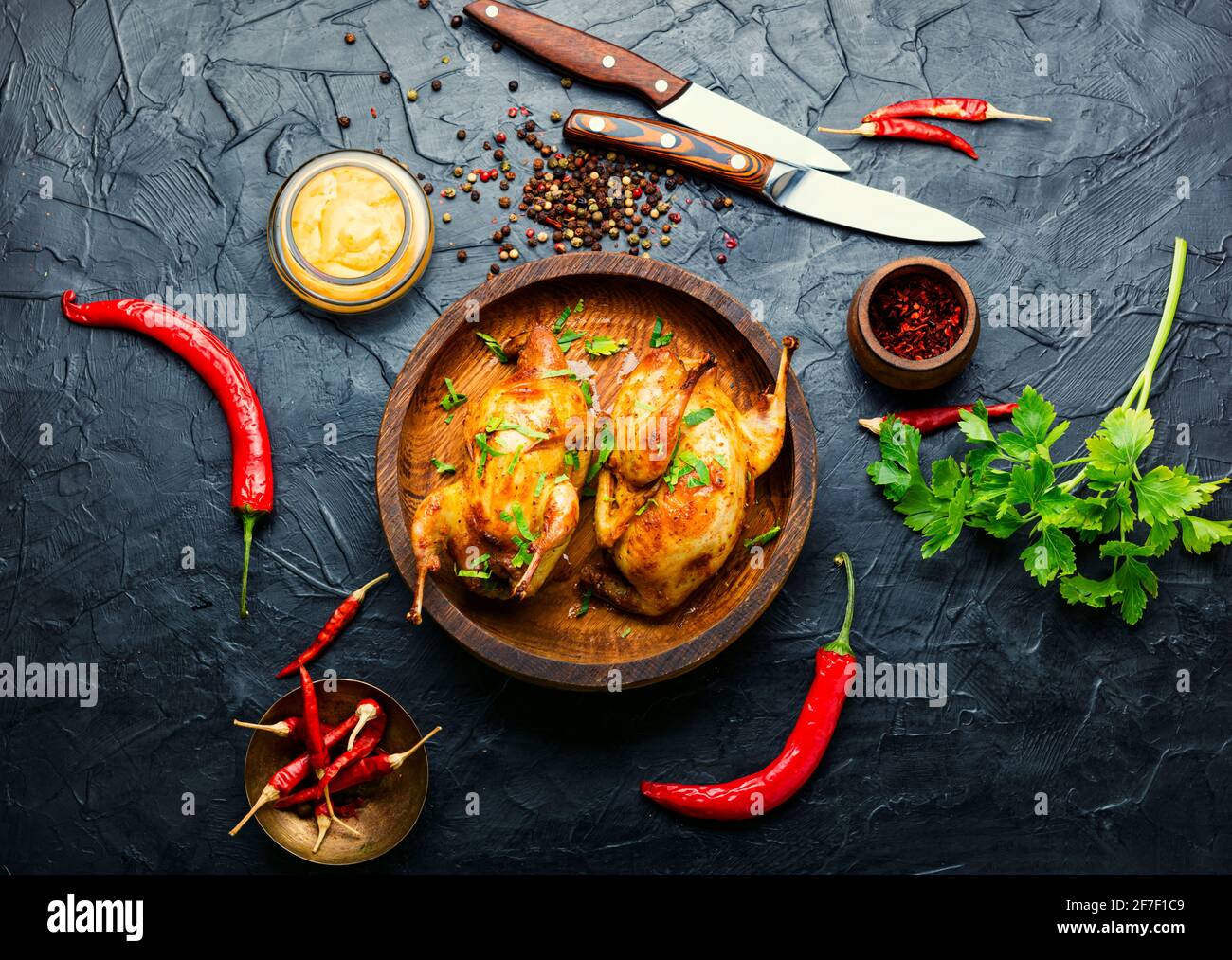 Roasted whole quail and spring vegetable salad.Tasty grilled quails