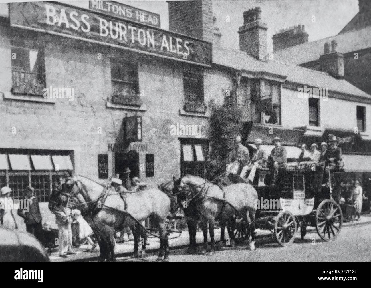 Vintage photograph of the Miltons Head in Buxton, Derbyshire. Old pub with coach and horses outside with bystanders and passengers looking on. Stock Photo