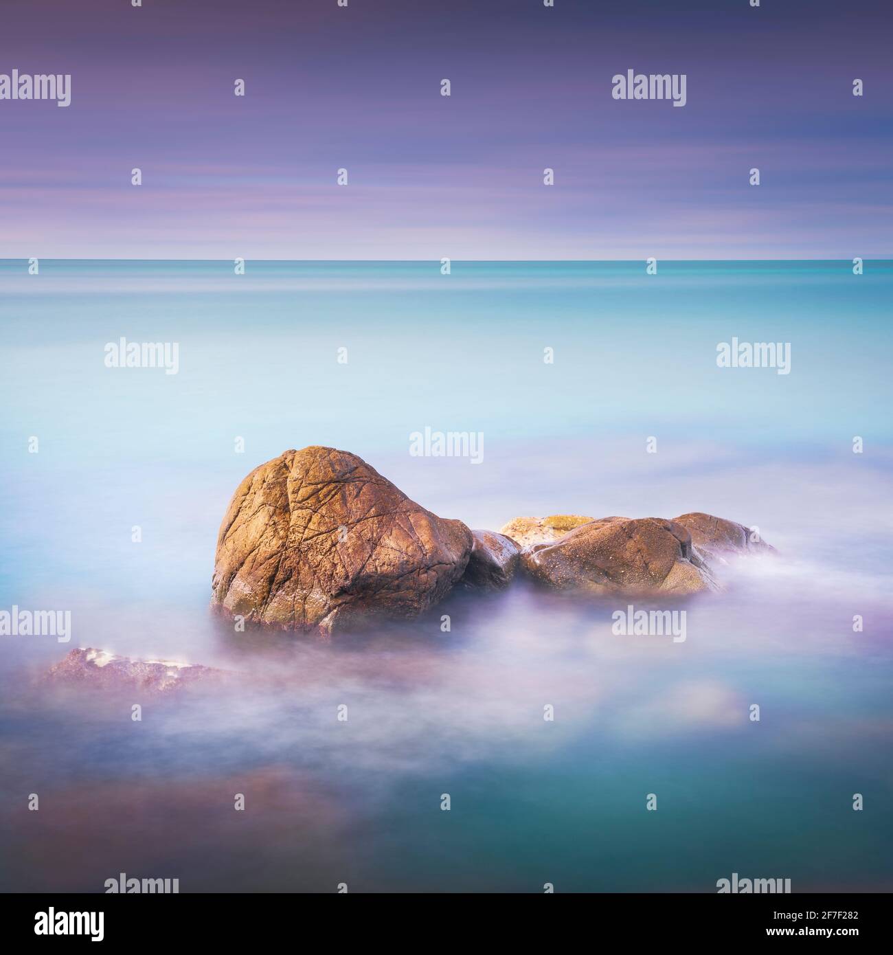 Rocks, soft sea and clouds in the sky, beautiful landscape in long exposure photography. Castiglioncello, Tuscany, Italy. Stock Photo