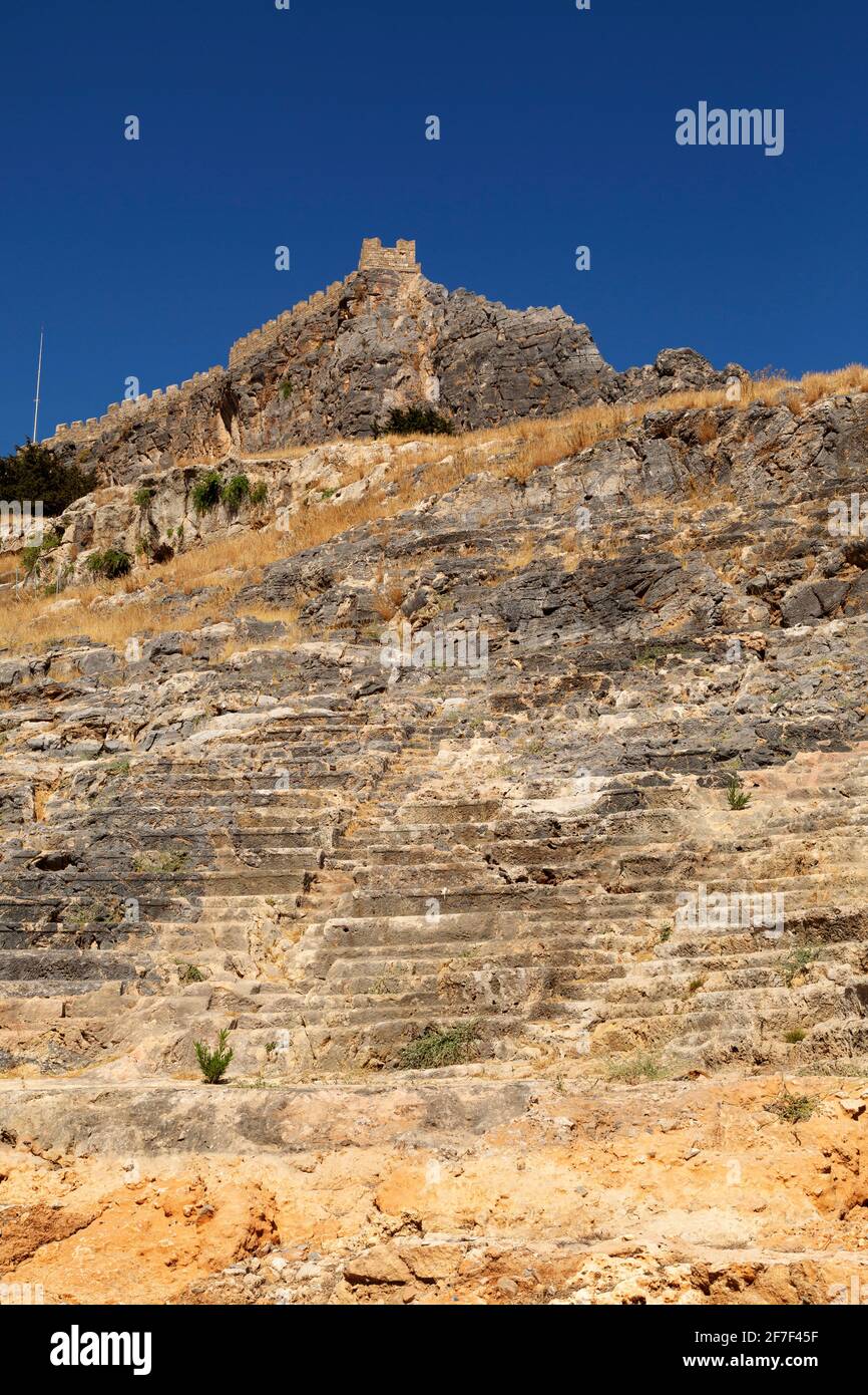 Seating in the ancient theatre at the foot of the Lindian Acropolis in Lindos, on Rhodes, Greece. The venue was used as a place of entertainment. Stock Photo