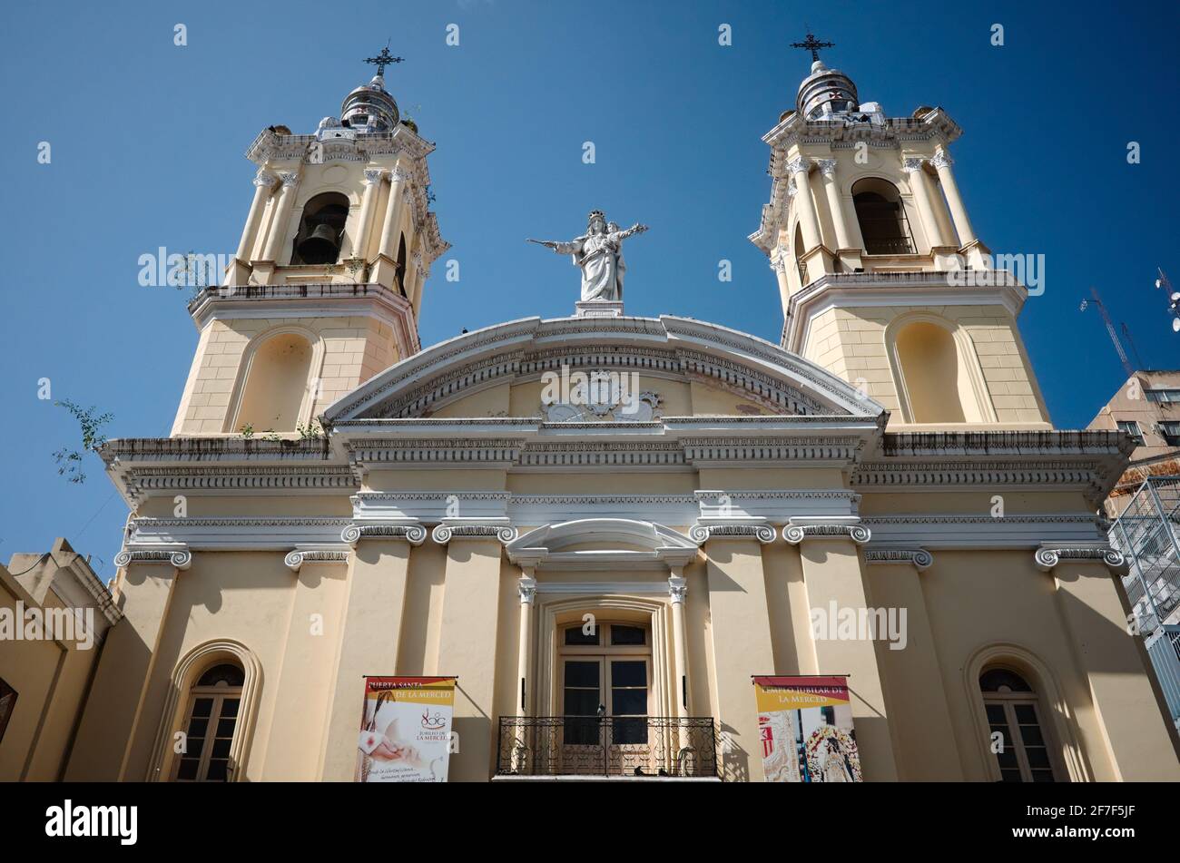 Cordoba, Argentina - January, 2020: Catholic church with two bell towers and statue of the Virgin Mary against blue sky. Stock Photo