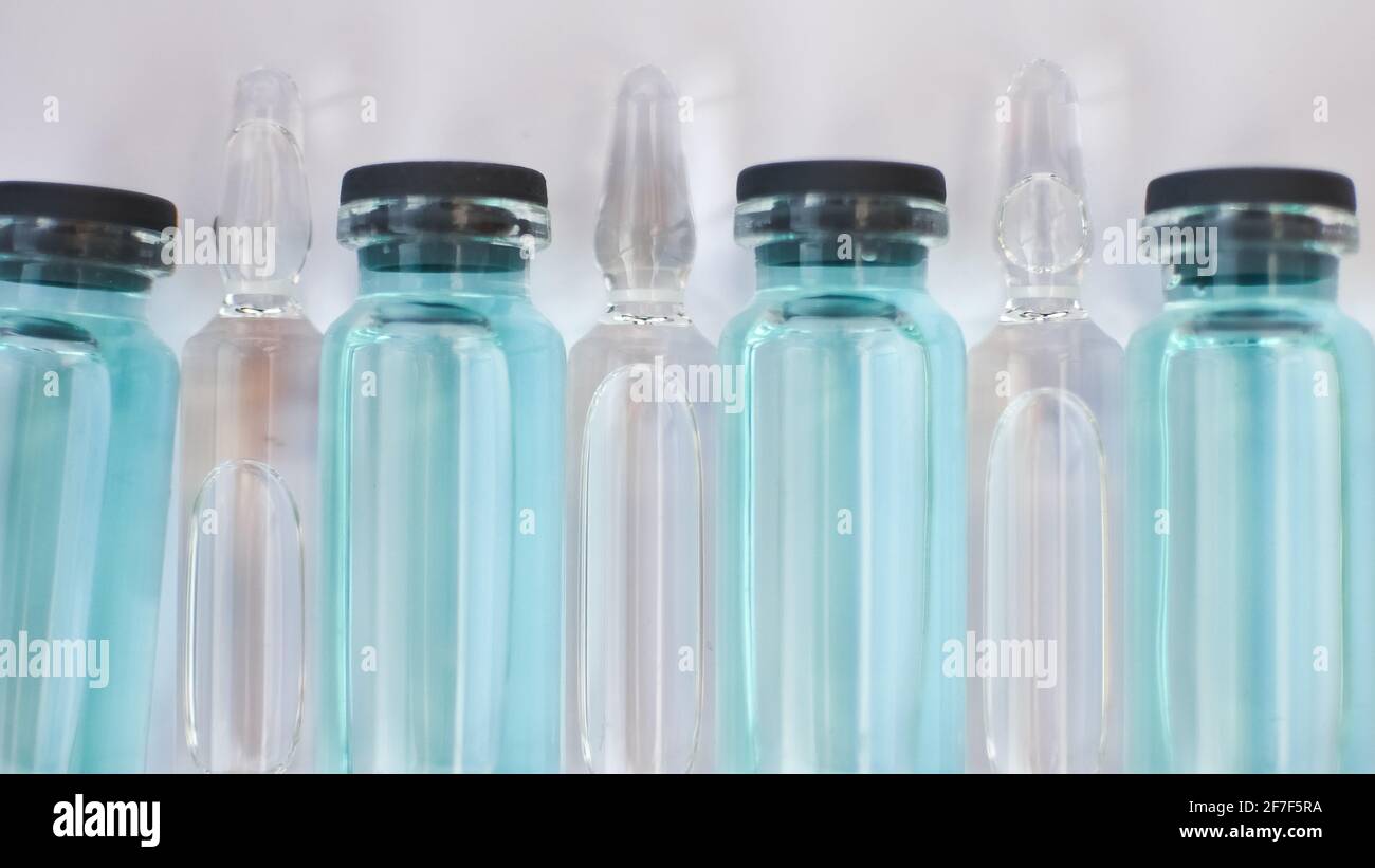 Vial vaccine, top view of glass ampoules with transparent and blue ...