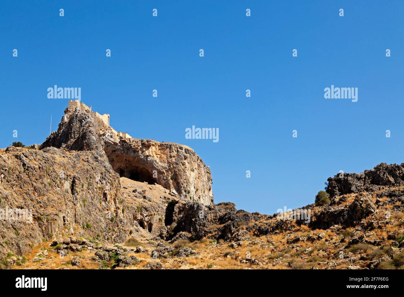 The Lindian Acropolis, an Ancient Greek citadel, on a rocky outcrop in Lindos on Rhodes, Greece. The citadel was later a base for the Knights of St Jo Stock Photo