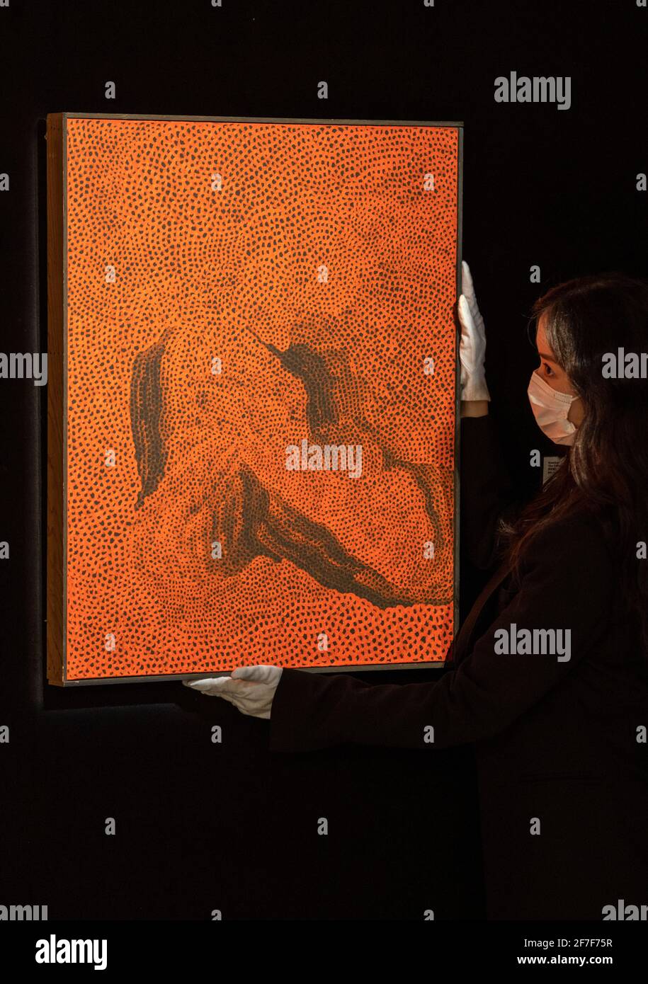 HONG KONG,HONG KONG SAR,CHINA: APRIL 7th 2021. Rare unseen works by Japanese painter Yayoi KUSAMA are up for sale at Bonhams New York  in their next auction. 6 of the 8 works are unveiled in the Bonhams gallery Hong Kong to generate presale interest. Cristina Wang, specialist of modern and contemporary art Hong Kong, adjusts the ÒHudson RiverÓ  Alamy Live news/Jayne Russell Stock Photo