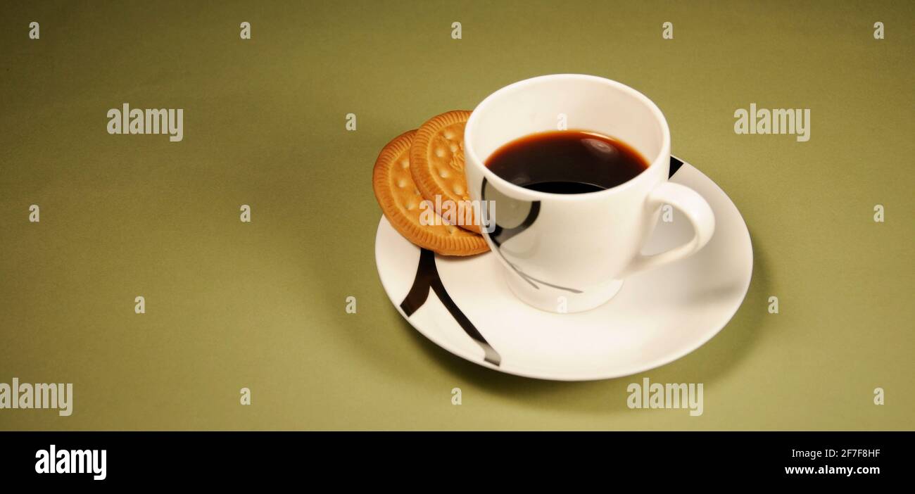 Tea cup with biscuits in saucer Stock Photo Alamy