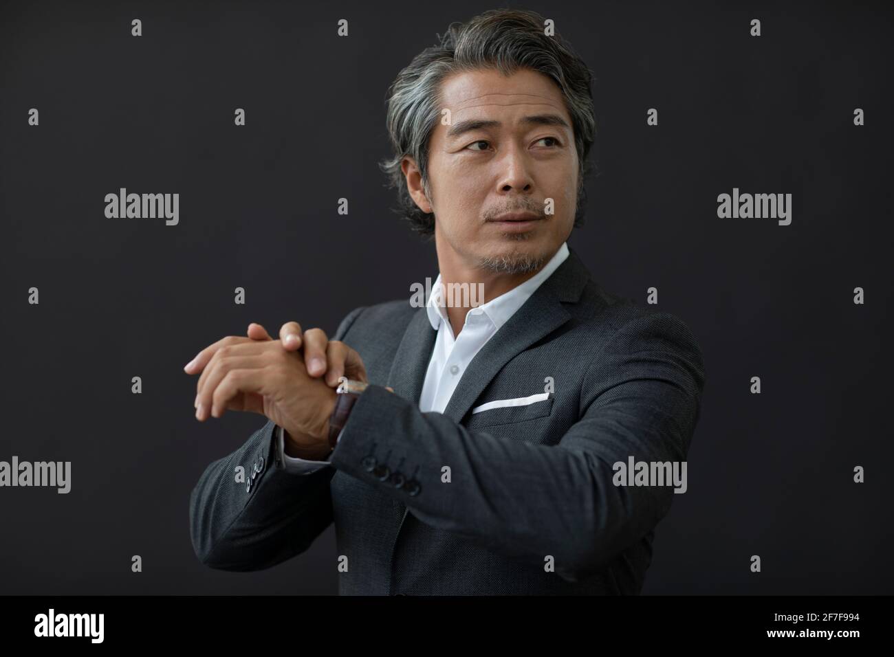 Successful businessman checking the time Stock Photo - Alamy