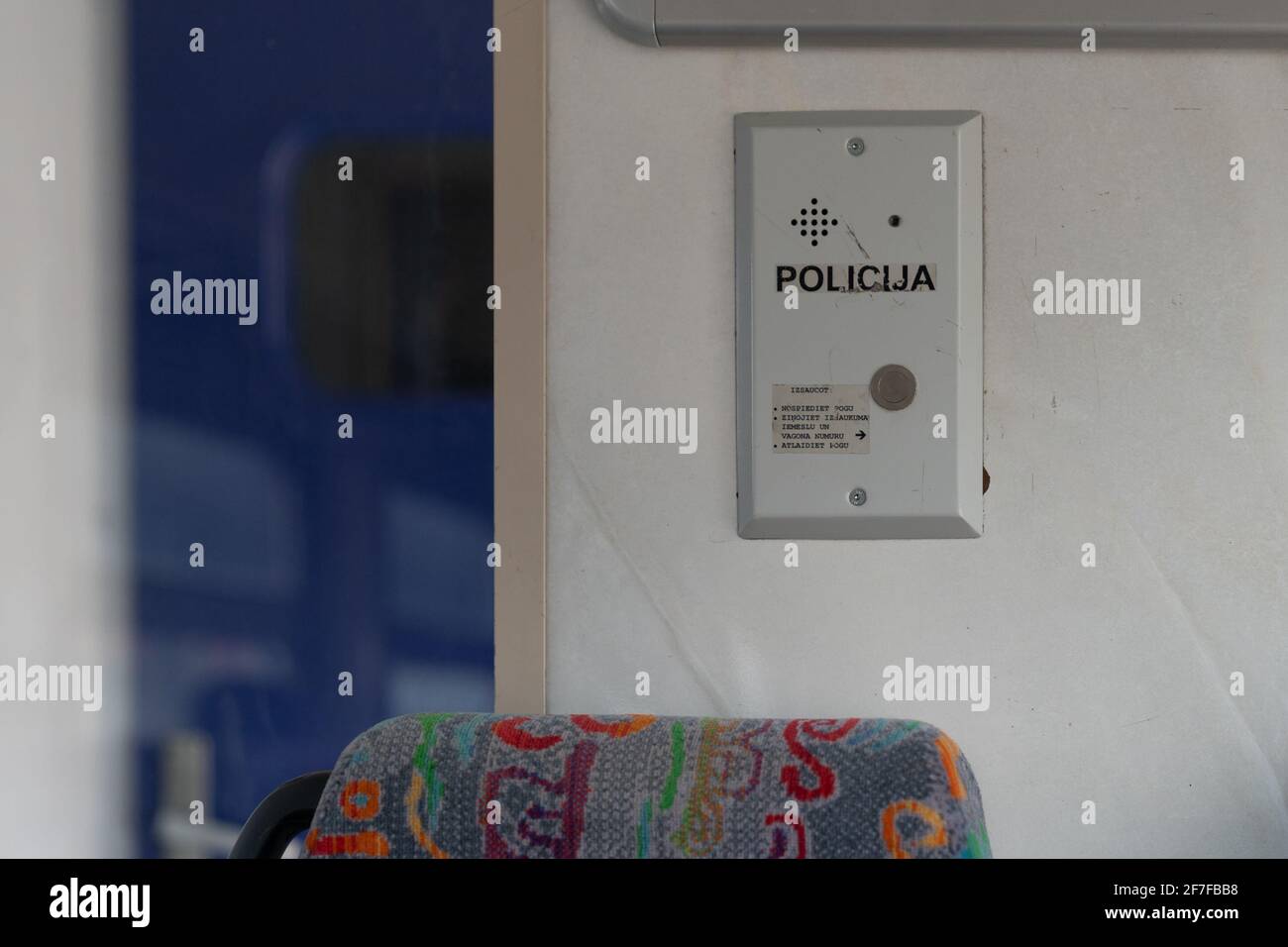 Latvia - 03.16.2020: interior view of train in Latvia. Police call button on the wall. Stock Photo
