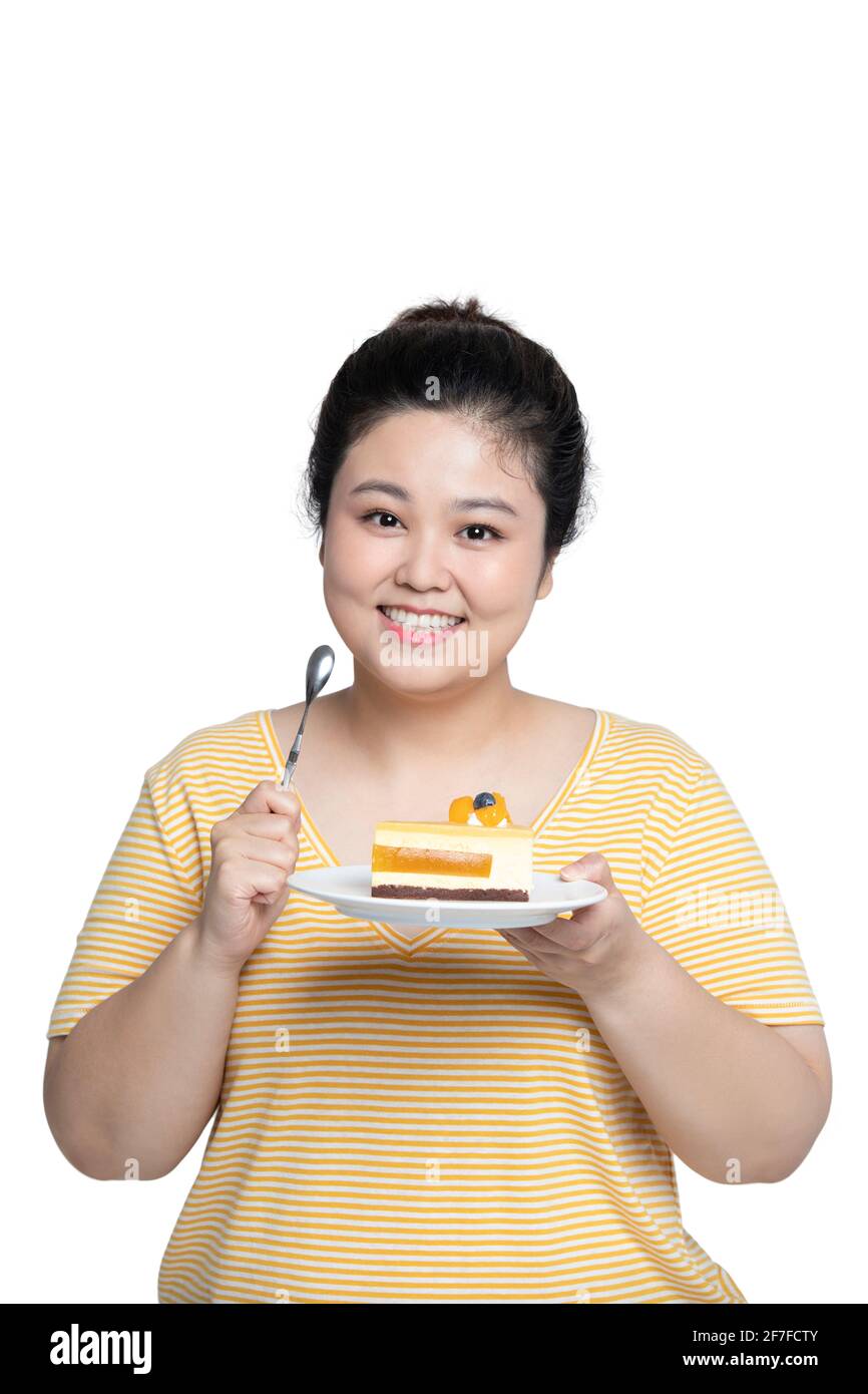 Young woman eating cake Stock Photo Alamy