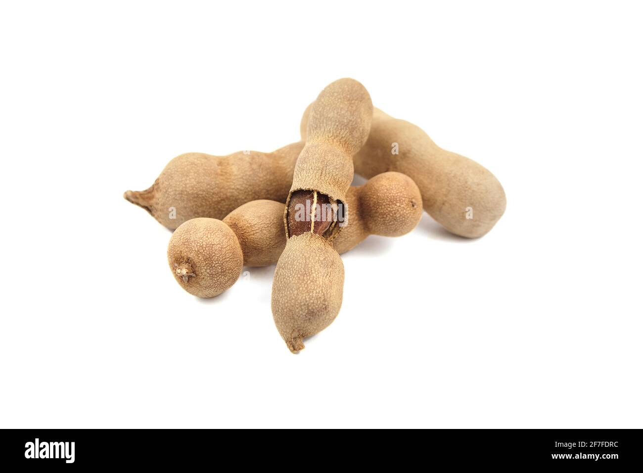 Tamarind fruit (indian date) isolated on white background. Group of tamarind pods. Heap of tropical fruits Stock Photo