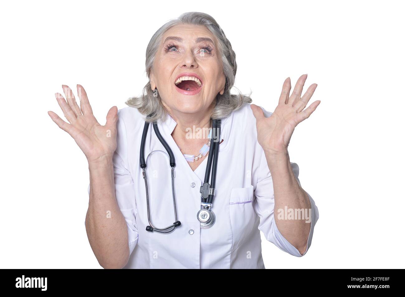 Happy senior doctor posing on white background Stock Photo - Alamy