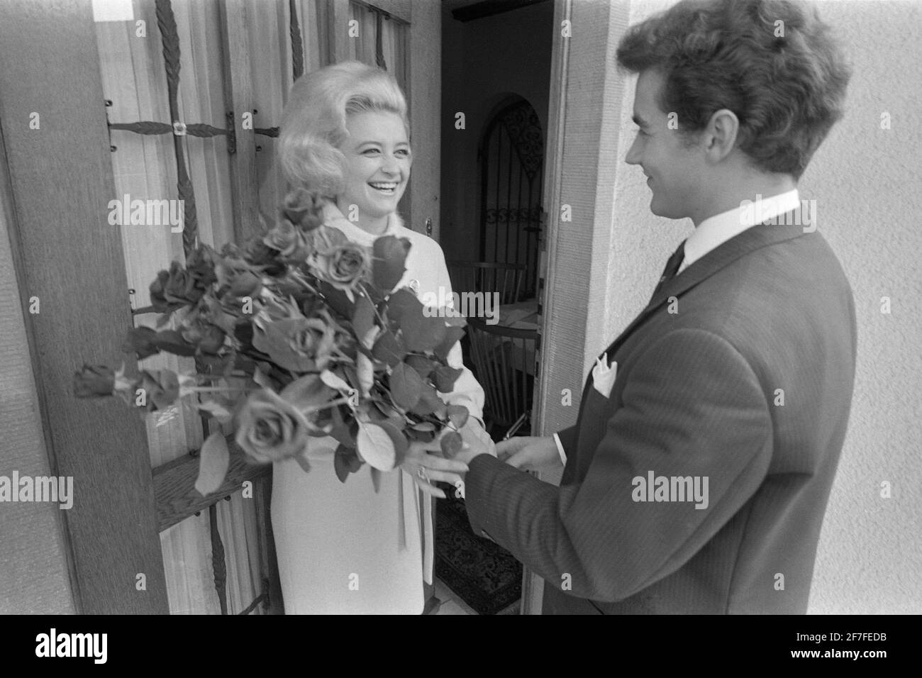 Hans Juergen BAEUMLER, figure skater, visits his figure skating partner Marika KILIUS and hands her a bouquet of roses, Hamburg on May 23, 1964, Â | usage worldwide Stock Photo