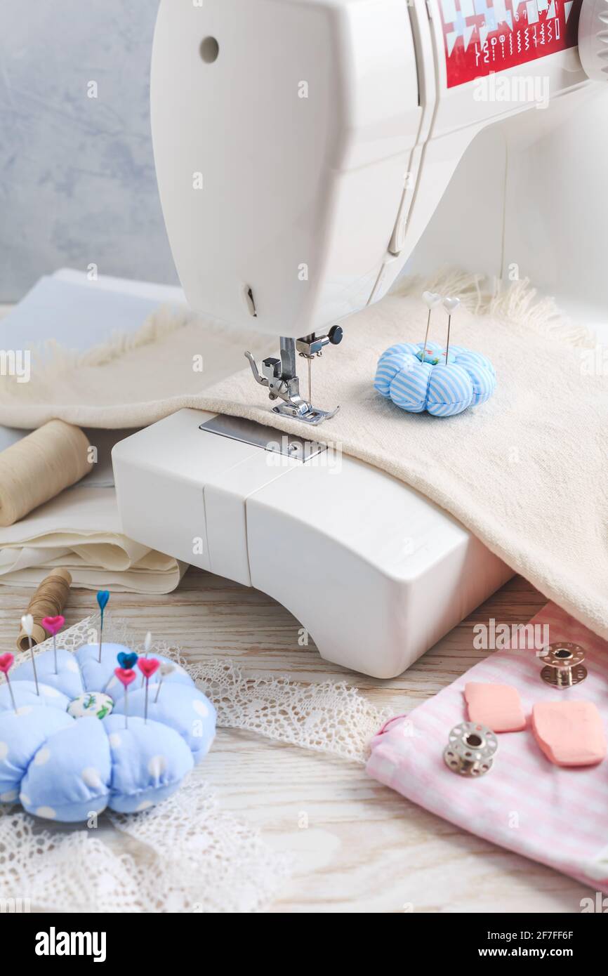 Sewing machine, tools and supplies. Hobby, crafting, creativity, free time at home concept. Stock Photo