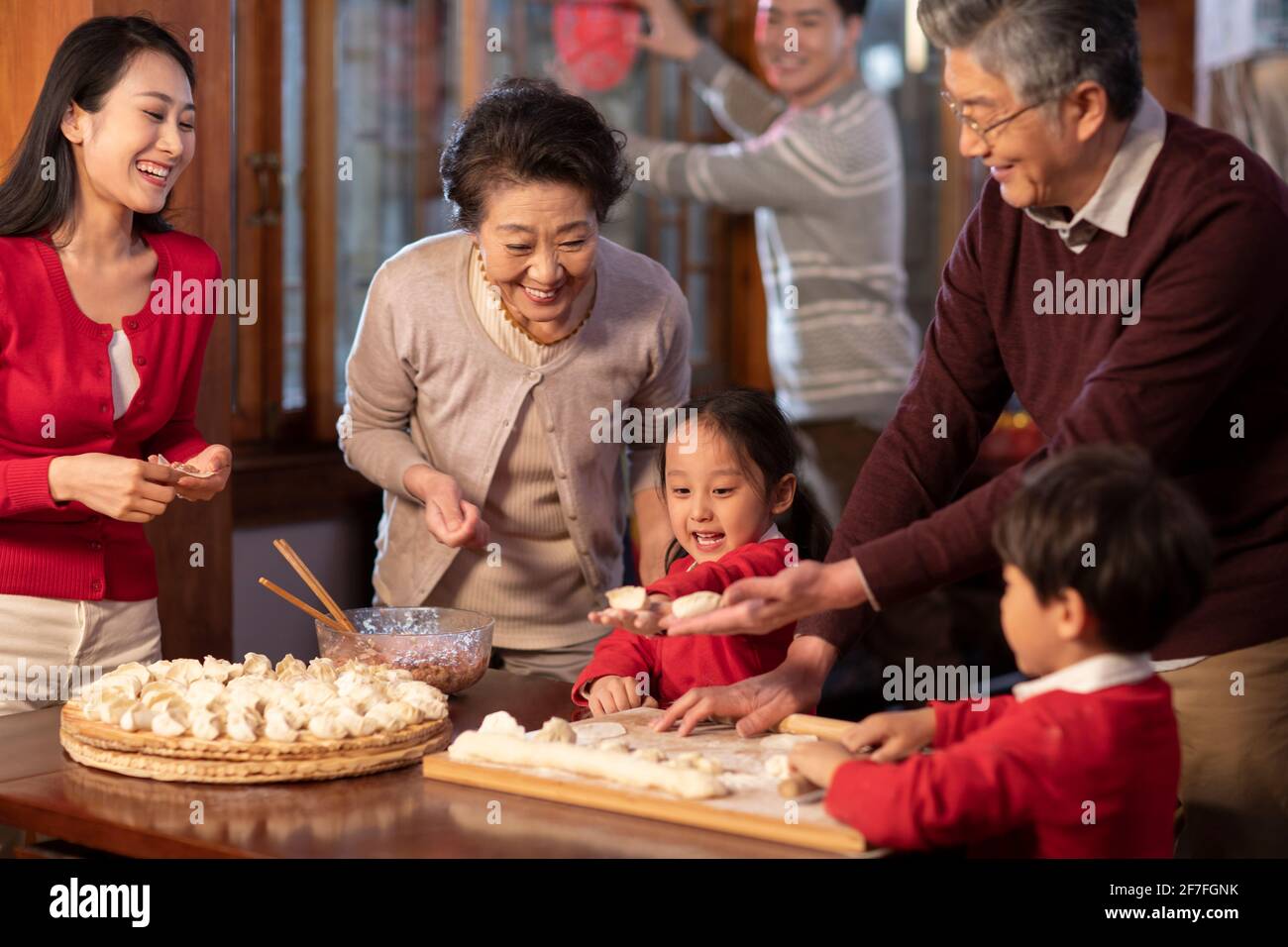 Happy family making dumplings Stock Photo
