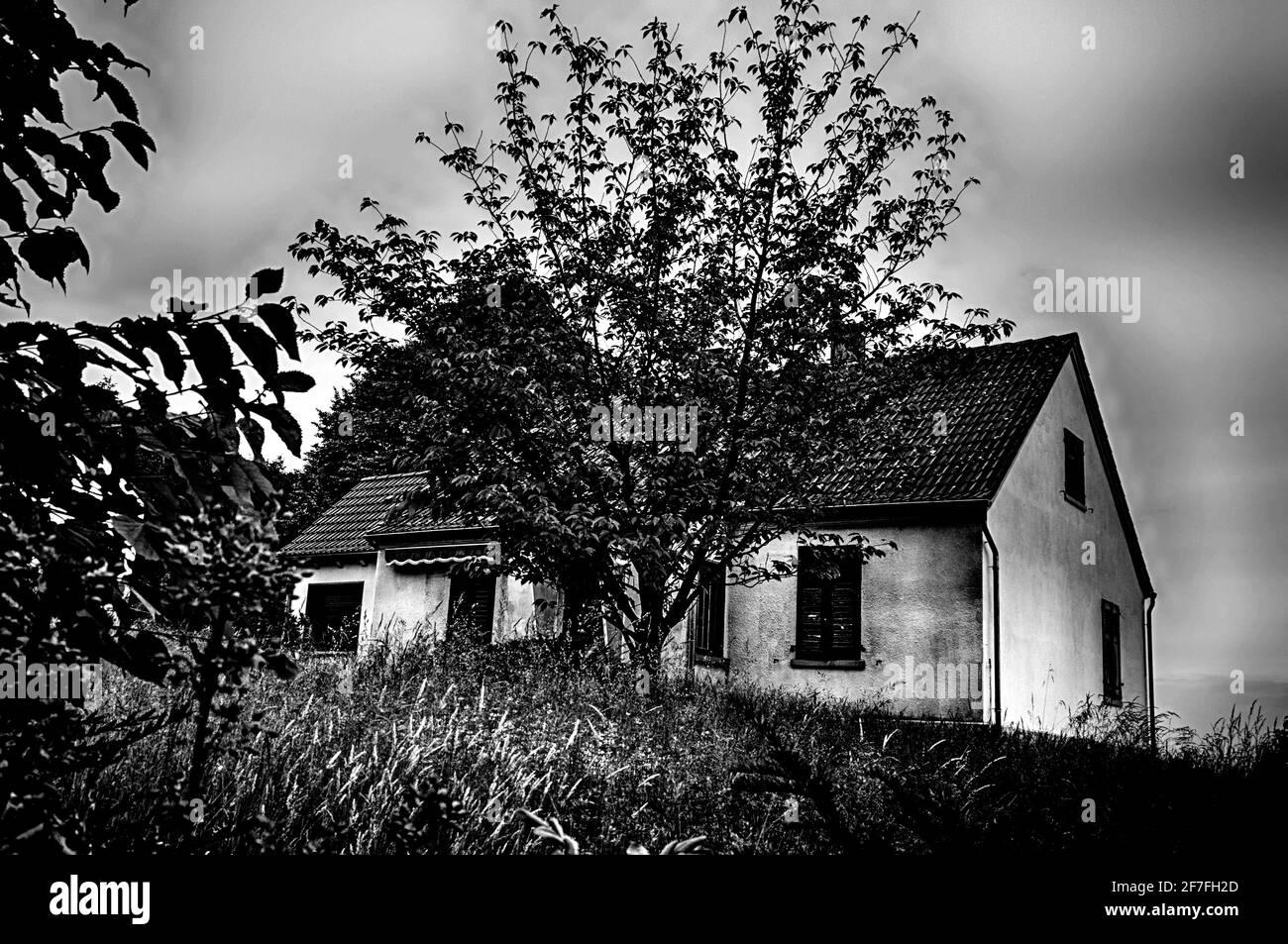 Spooky house with closed window shutter; unheimliches haus mit geschlossenen fensterläden Stock Photo