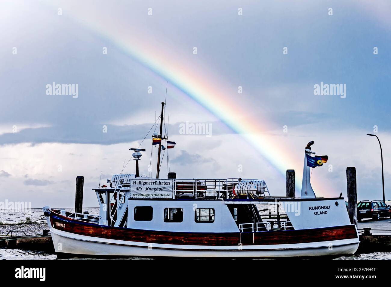 Boat in a Harbour in Northern Germany with a rainbow at the sky Stock Photo