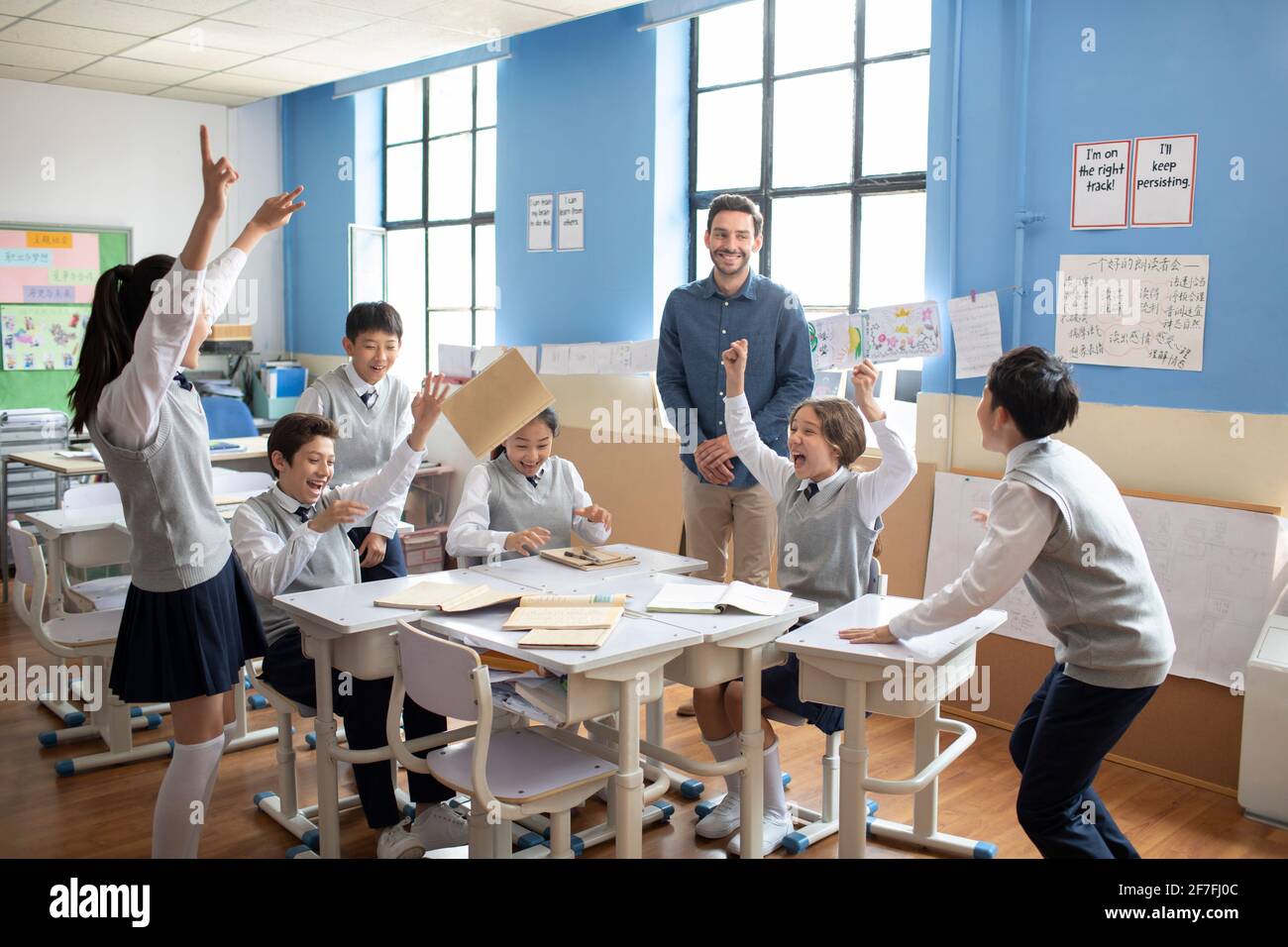 Students and teacher celebrating Stock Photo