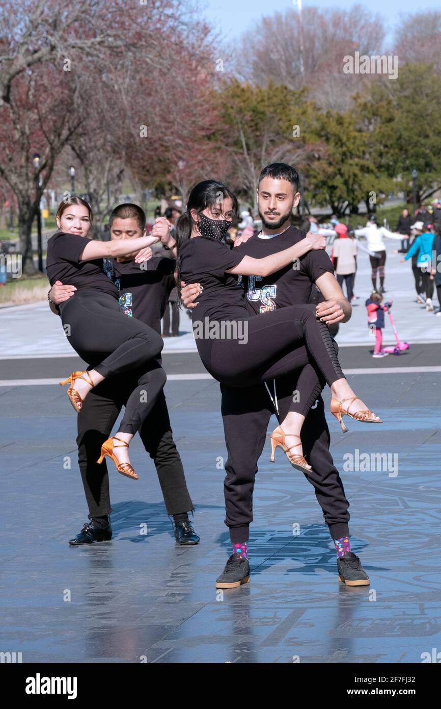 Dancers from the Cali Salsa Pal Mundo dance studio film a performance in public to publicize their school. In Flushing Meadows Corona Park in Queens Stock Photo