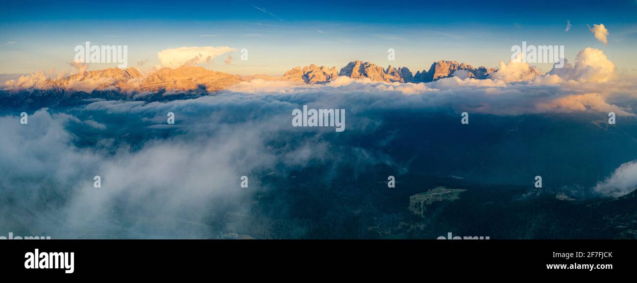 Aerial panoramic view of Brenta Dolomites emerging from clouds, Madonna di Campiglio, Trento, Trentino-Alto Adige, Italy, Europe Stock Photo