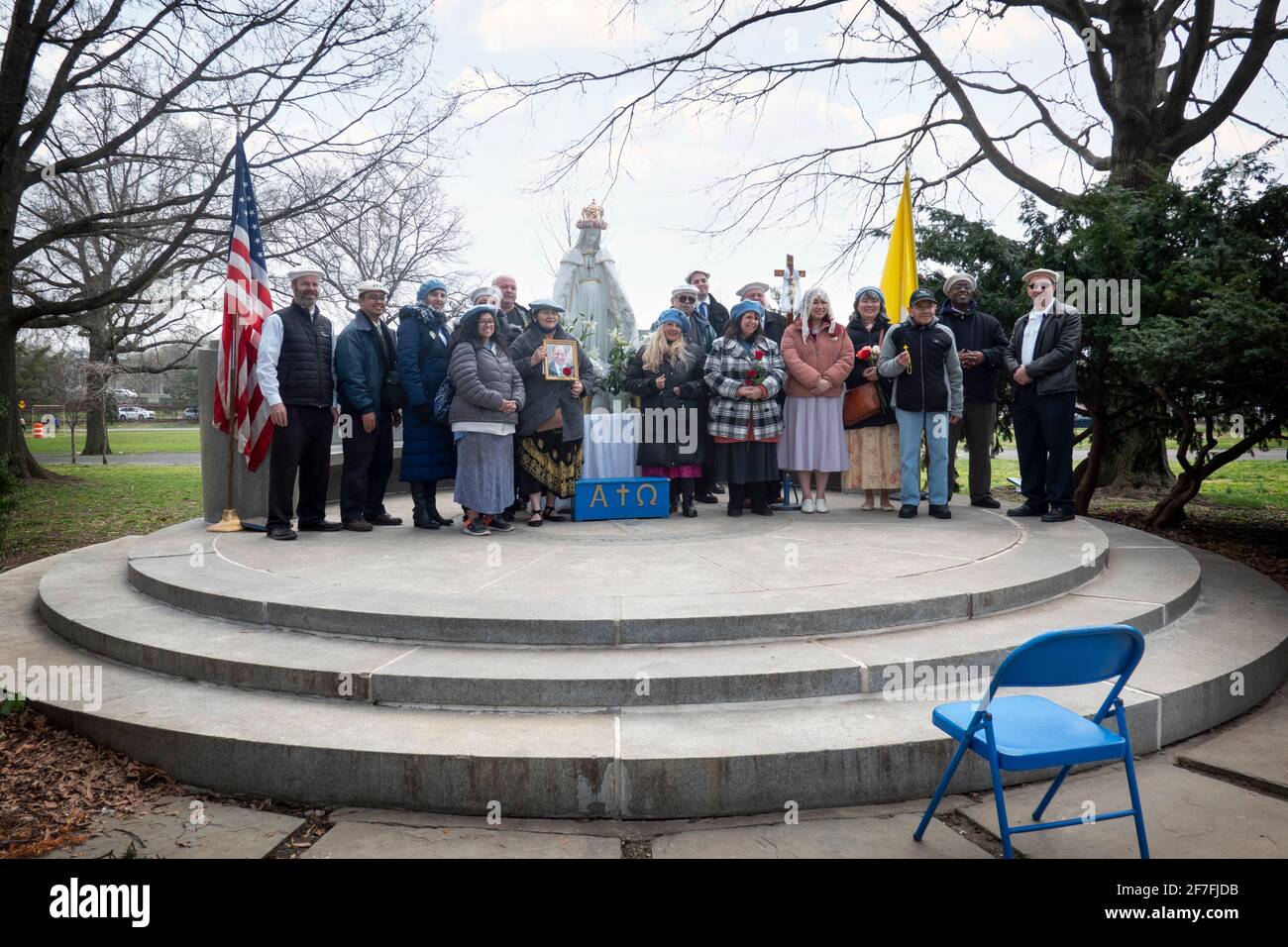 After an outdoor prayer service a group of Roman Catholics pose on their makeshift altar with the chair used by Veronica Lueken in the foreground. Stock Photo