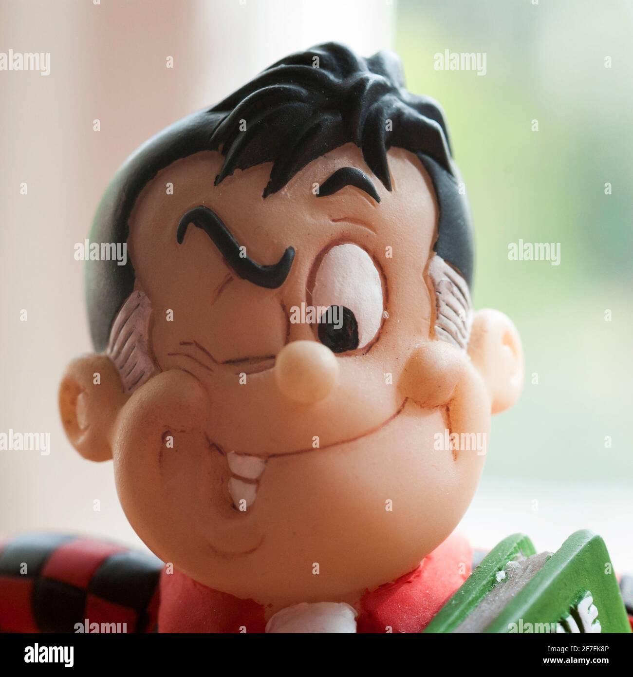 A close up of the head of a small figurine of Roger the Dodger, a character from the DC Thomson comic, The Beano. Stock Photo