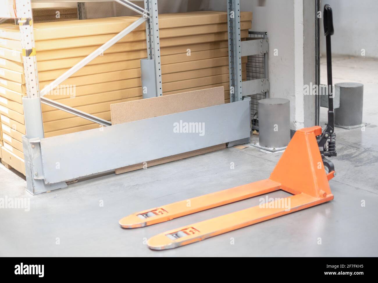 The Industrial hand lift equipment for lift the cardboard box on to the rack in the store warehouse. Stock Photo