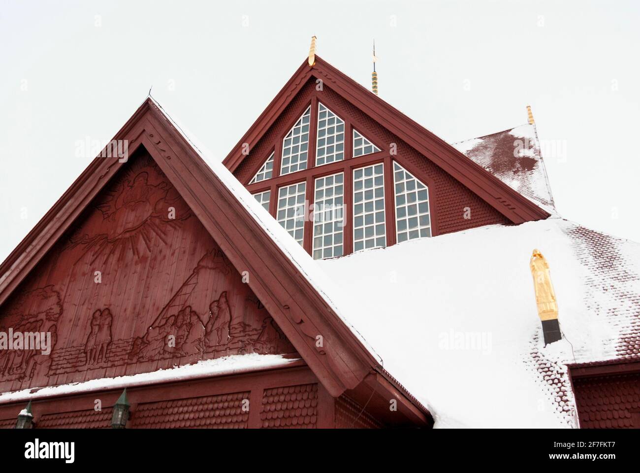 A detail of the red, wooden Kiruna Church, its roof covered in snow (Lapland, Sweden) Stock Photo