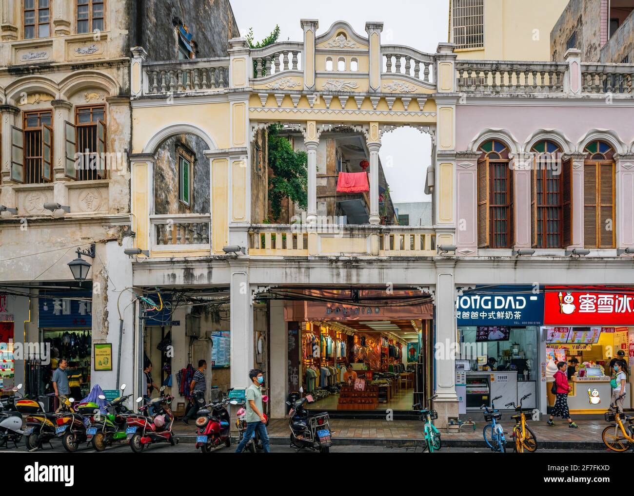Haikou China , 21 March 2021 : Facade of old colonial sotto portico building with shop behind in Xinhua north road in Haikou Qilou old town Hainan Chi Stock Photo