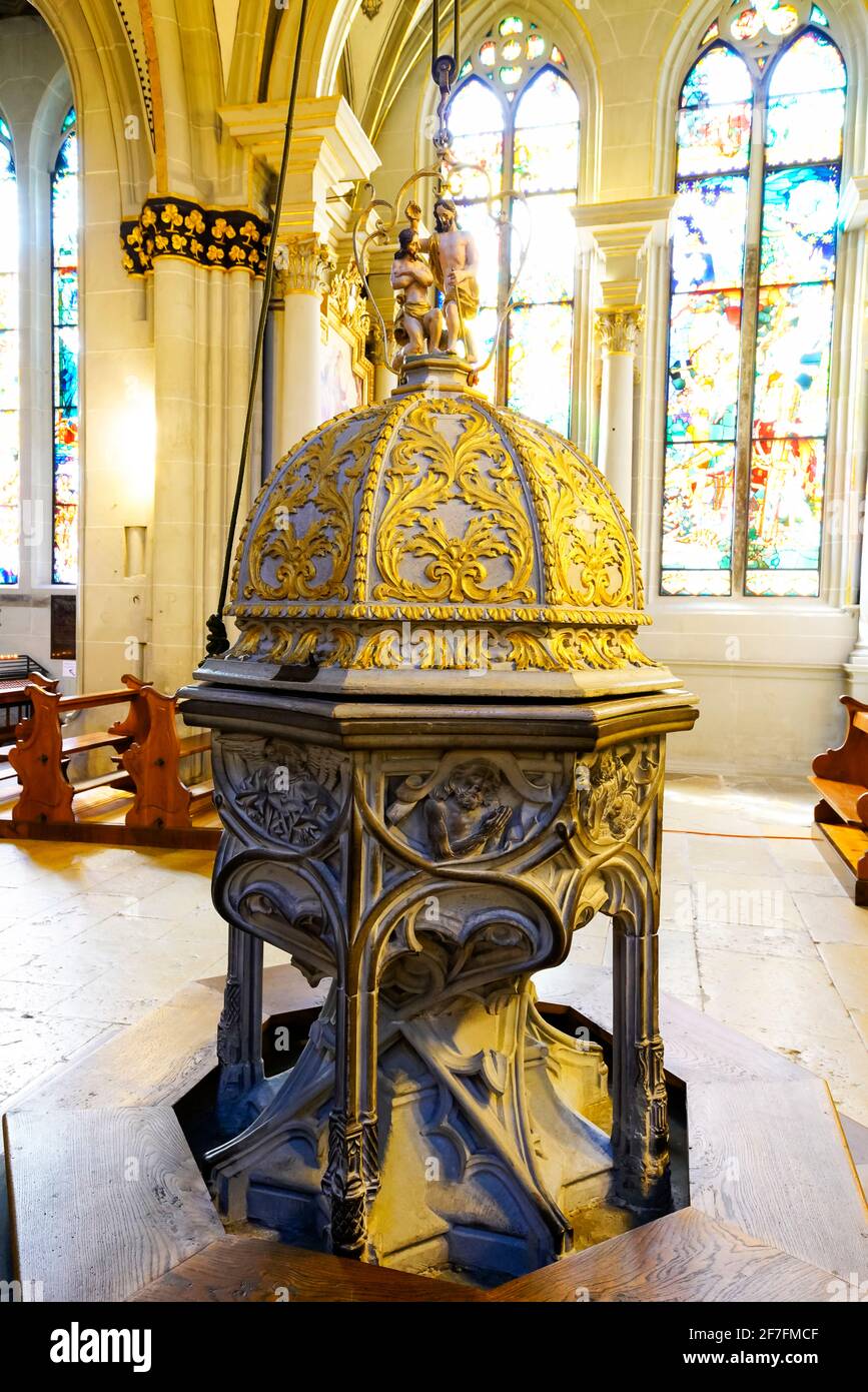 Octagonalshape baptismal font with goldleaf decoration in StNicholas Cathedral in Fribourg